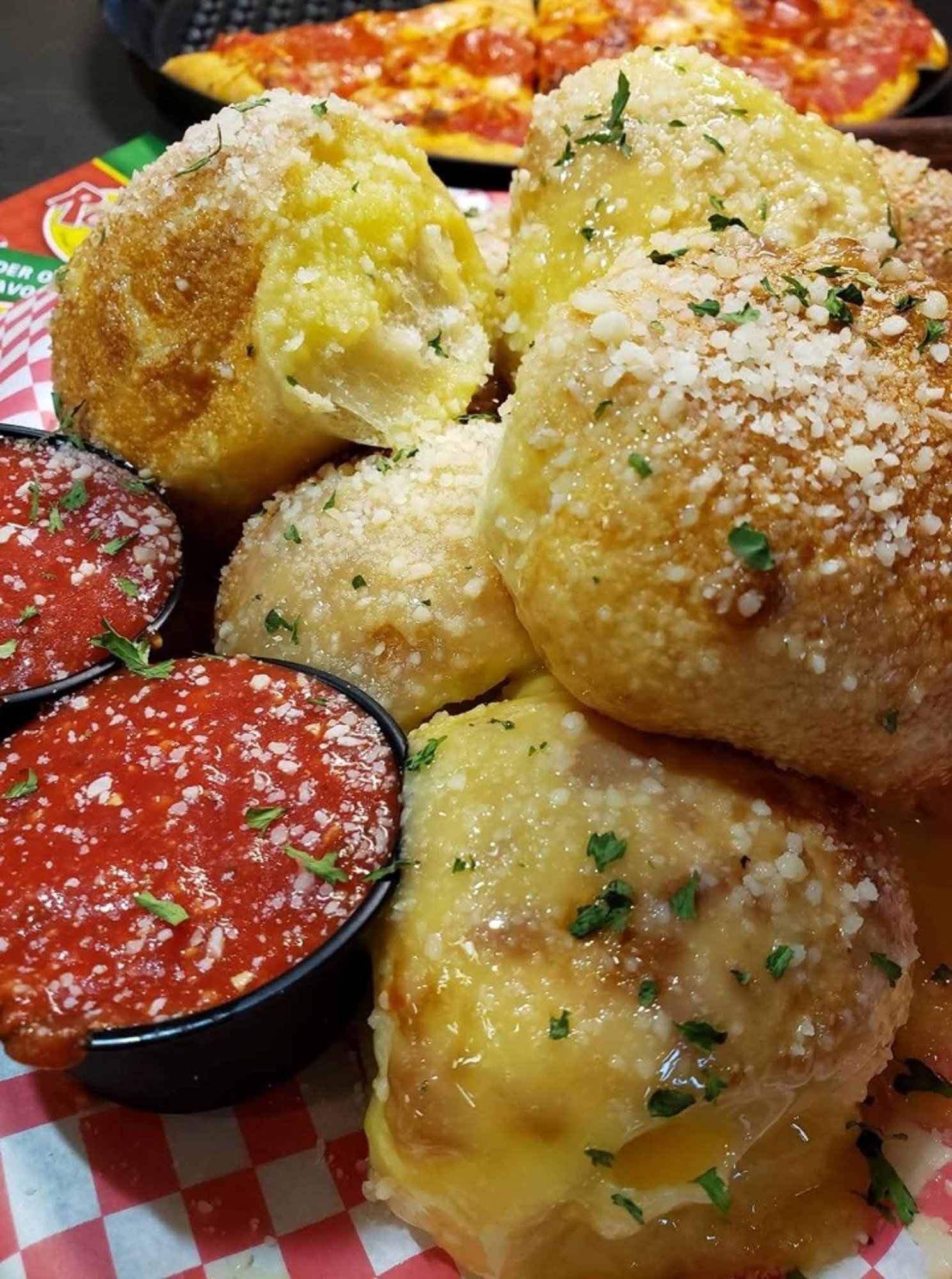 GARLIC PARMESAN BITES fried bites of dough tossed in garlic butter & seasonings, served with mari...