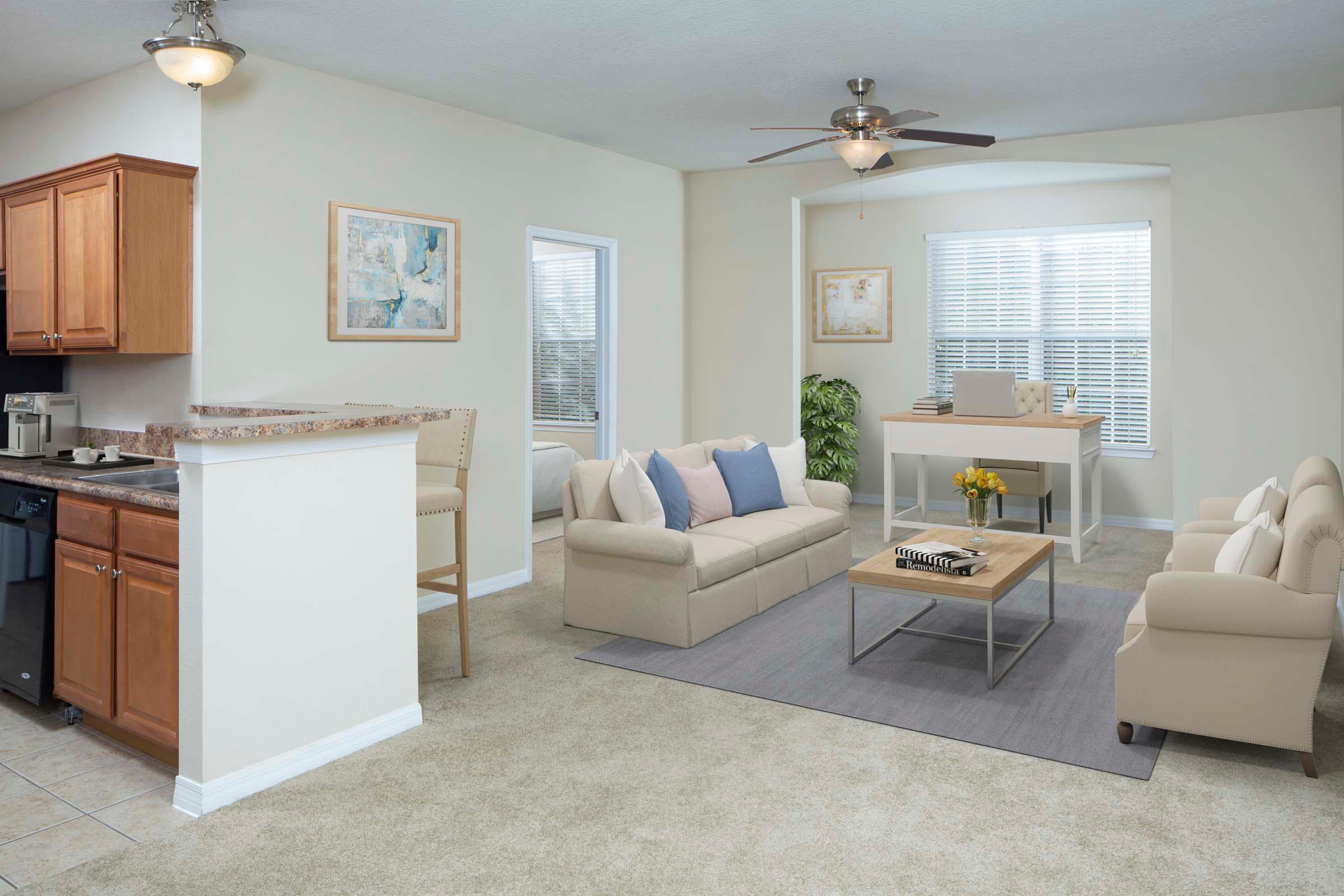 Living room with work from home space in solarium carpet flooring and ceiling fan