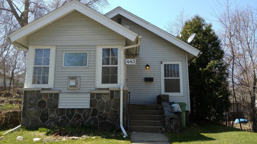 Cute bungalow with some really outstanding architectural features!  Stained glass window in front room above beautiful stone accent gas fireplace surround! Large family room, galley style kitchen with added bonus of a breakfast nook!  Laminate wood floors and jetted bathtub are some of the upgrades you can enjoy in this 2bed 1bath home!  Fenced in backyard, one car garage, and full DRY basement! 