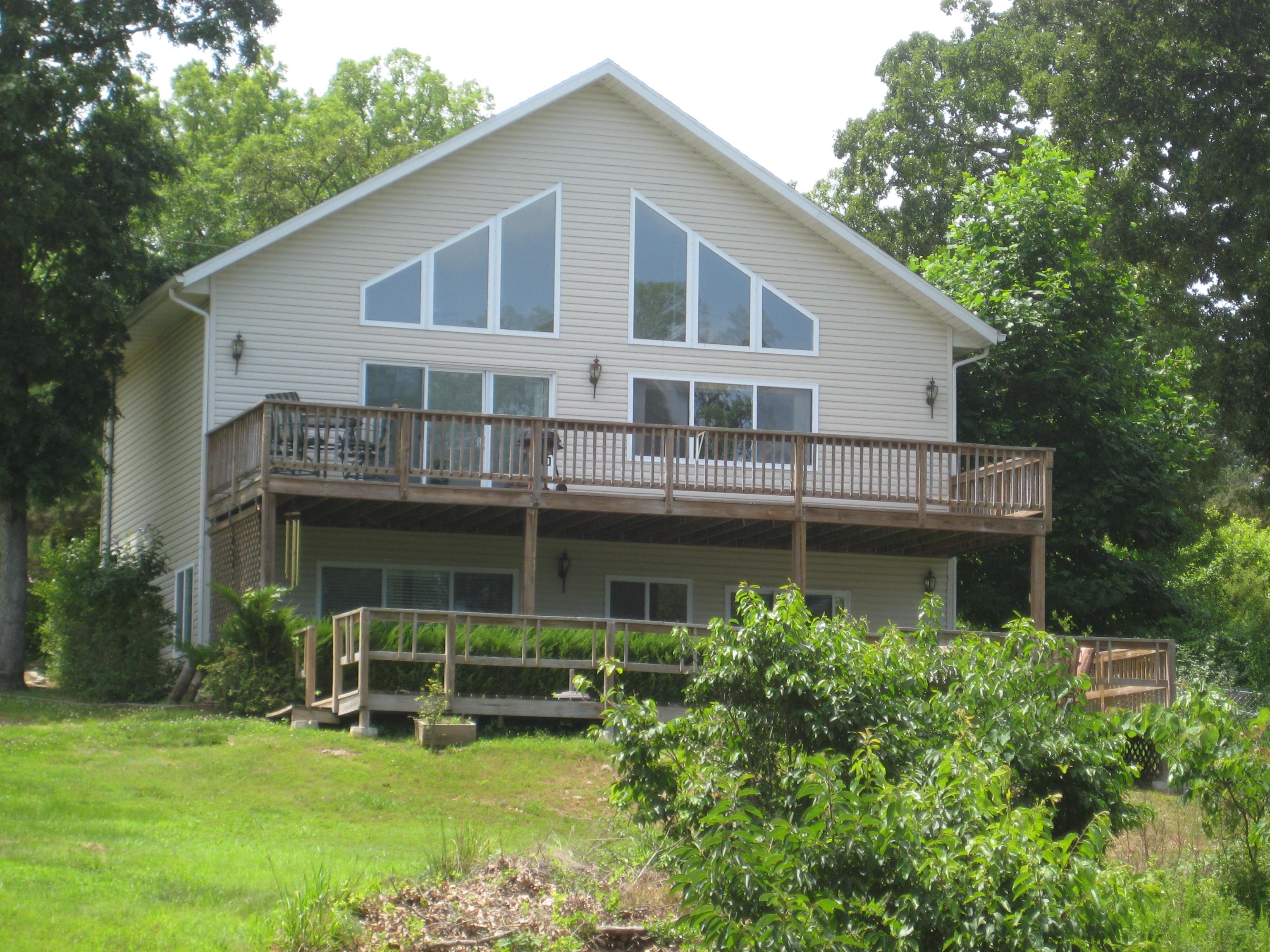 This Lake home is a great place to enjoy the Lake of the Ozarks. 3 BR -2 are MB with 4 baths. Family room with wet bar that opens out to deck with another bar over looking the Lake over 900 sq. ft of decking for your outdoor dining and enjoyment. A short walk to the water and a swim dock and boat slips.
