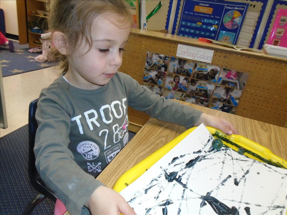 Our Preschool class is learning all about Wild Animals! This is Paige during small group time creating Zebra patterns while using marbles.