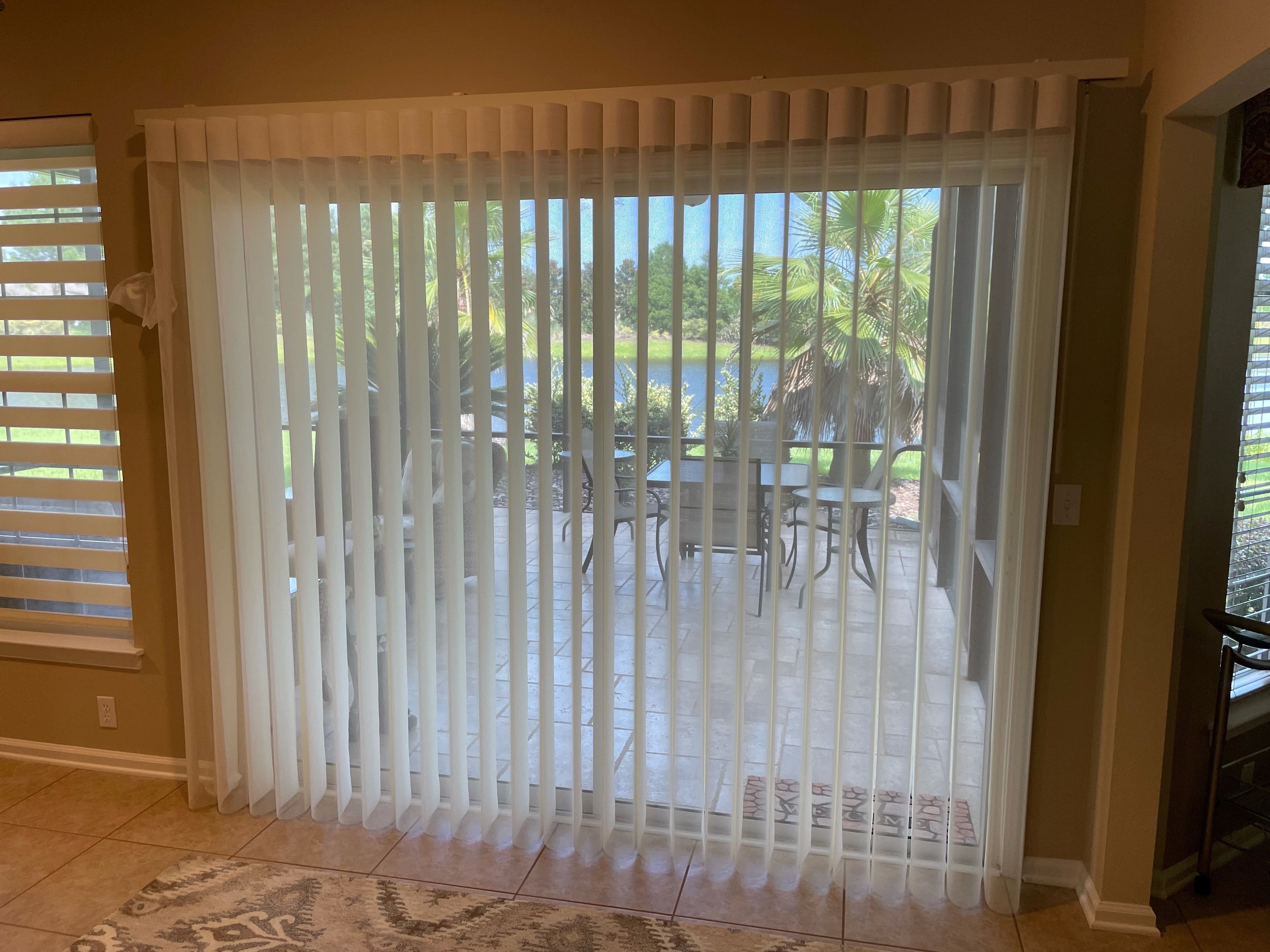 A great alternative for vertical blinds on a slider is a Smartdrape. It provides the same vertical design, with a soft fabric element to give a lighter touch in the room.