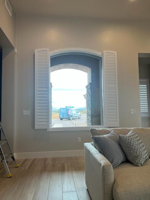 We recently installed this arched Shutter in a Green Valley residence.  This large window is in the living room near the entry way and provides a grand view on the front walkway.  Notice our van out front!