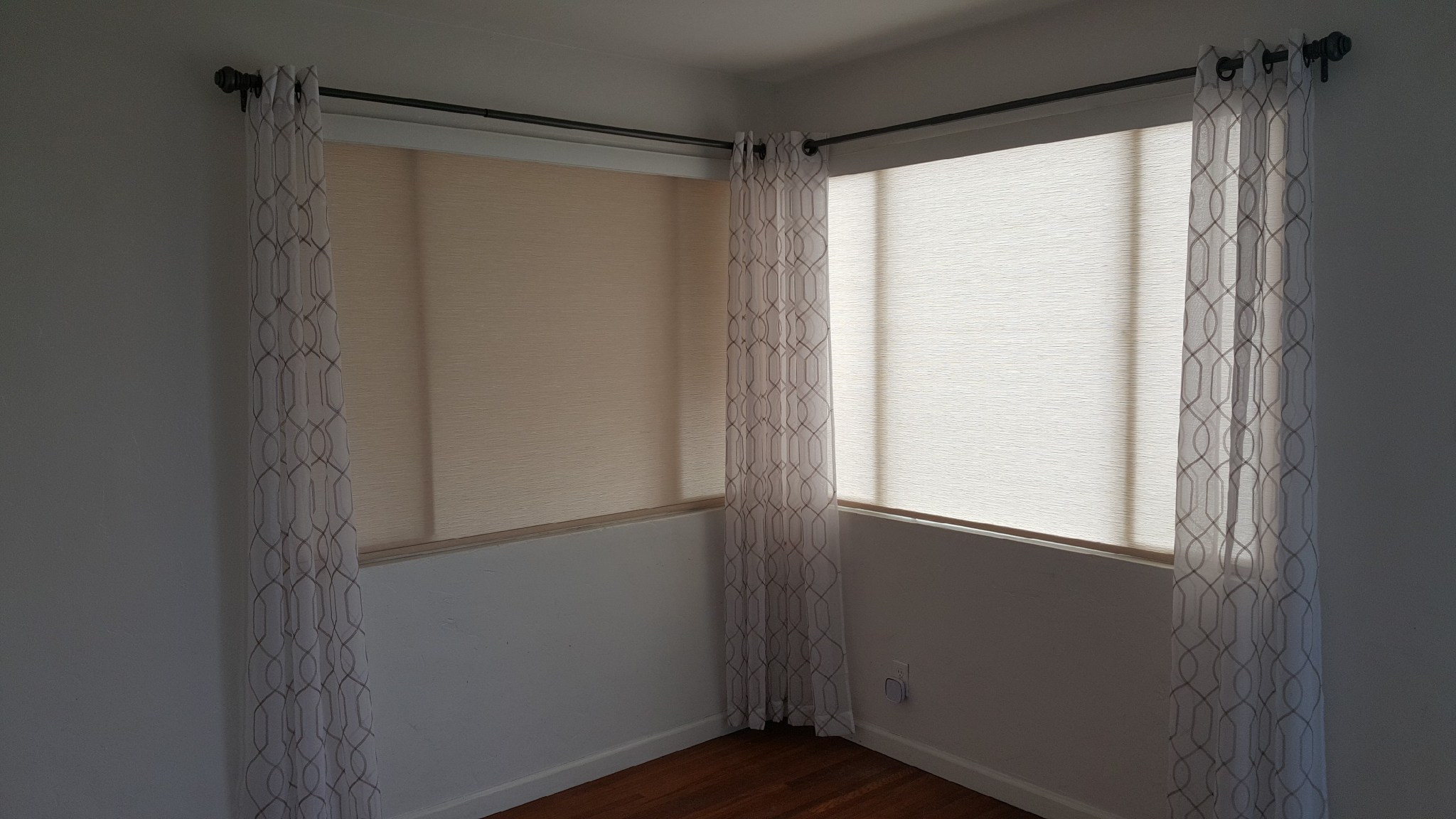 Roller Shades with Wood valance and customers own side panels in Clairemont.