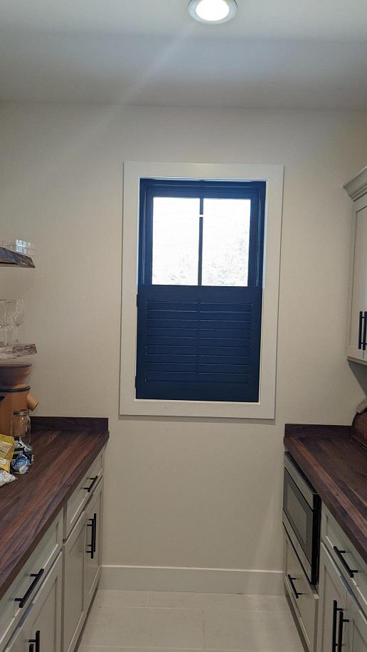 Curtains would have gotten in the way in this galley kitchen from Cedar Falls. We needed a good answer to shade the window and add some charm. Our CafeÌ Shutters work perfectly!