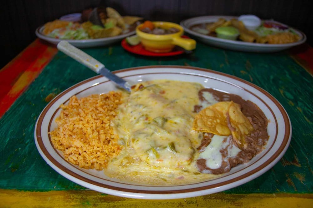 Hamburger Steak Topped with Chile Con Queso, Served with Refried Beans and Spanish Rice. Choice o...