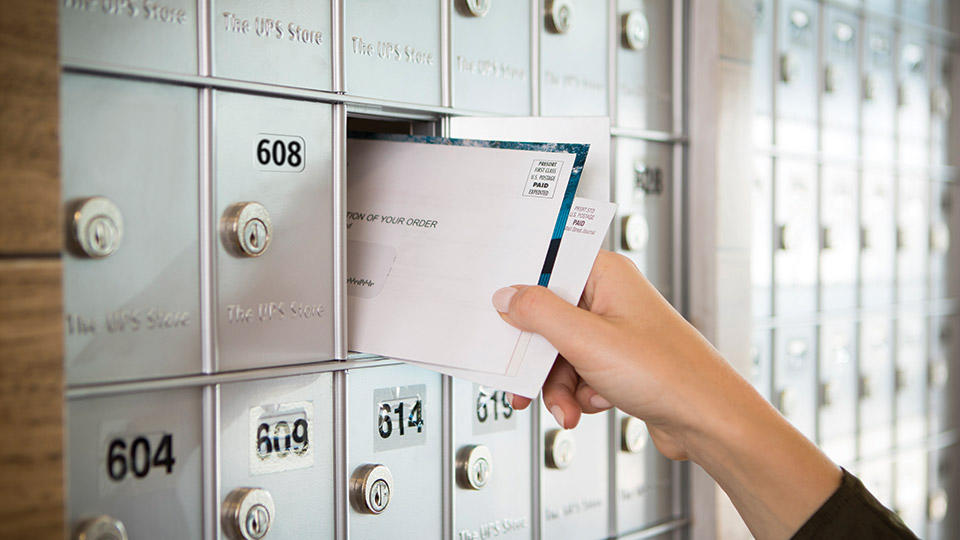 Person retrieving mail from mailbox