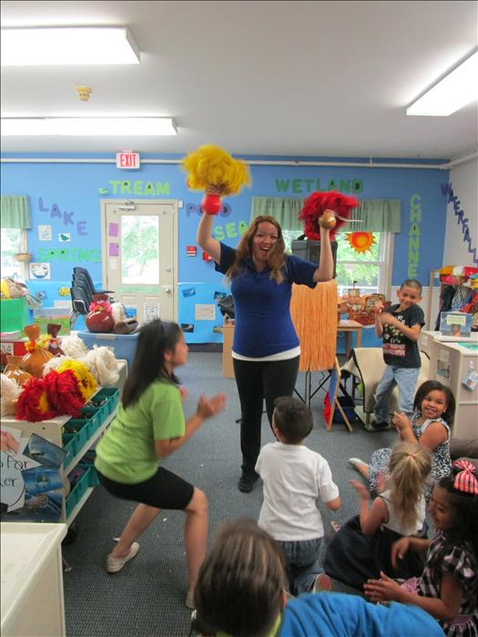 Ms. Lupita showing our school age children how to Hula.