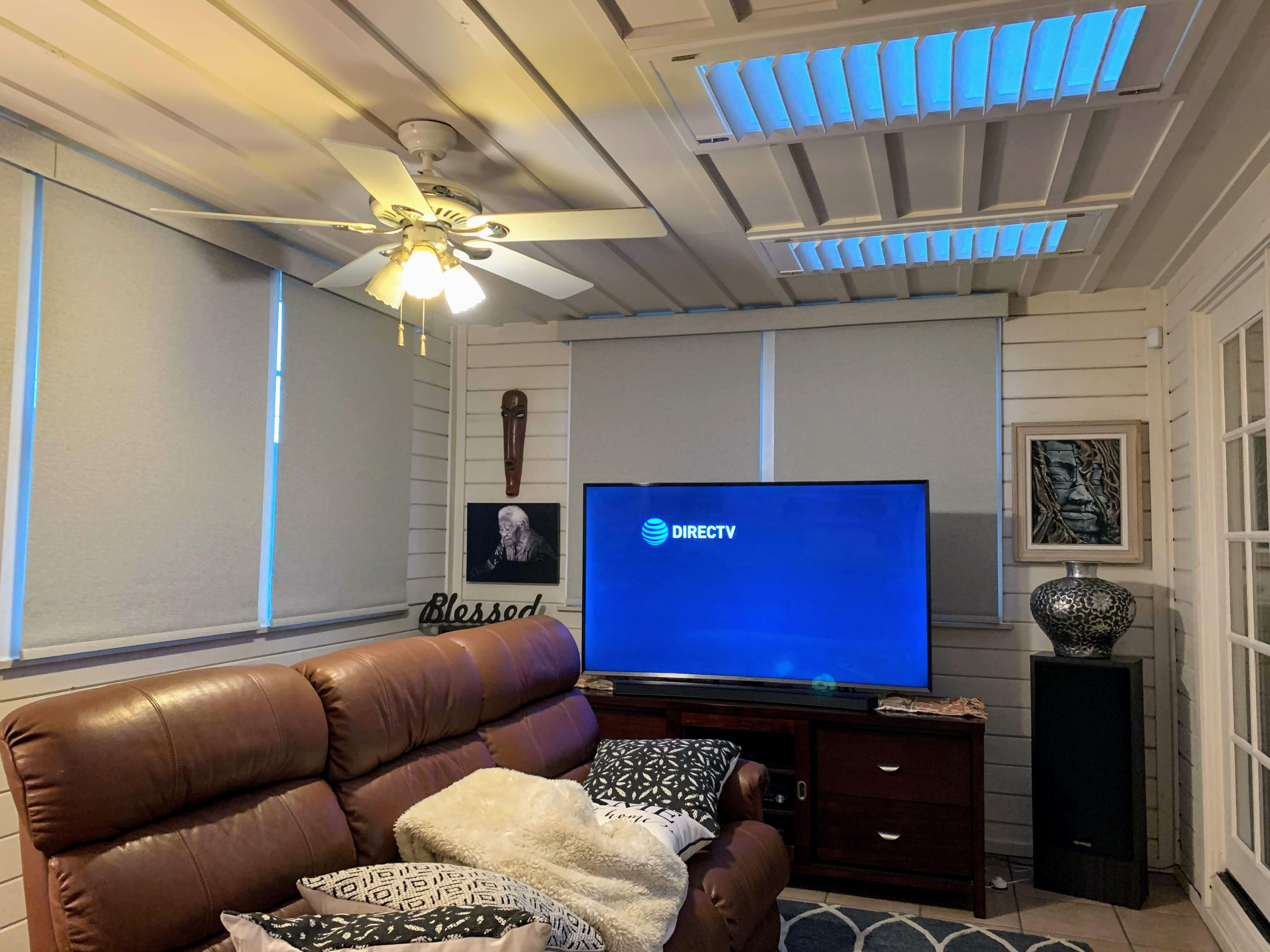 Motorized roller shades installed throughout this living room. Blackout fabric for light control, reduce glare and heat.
