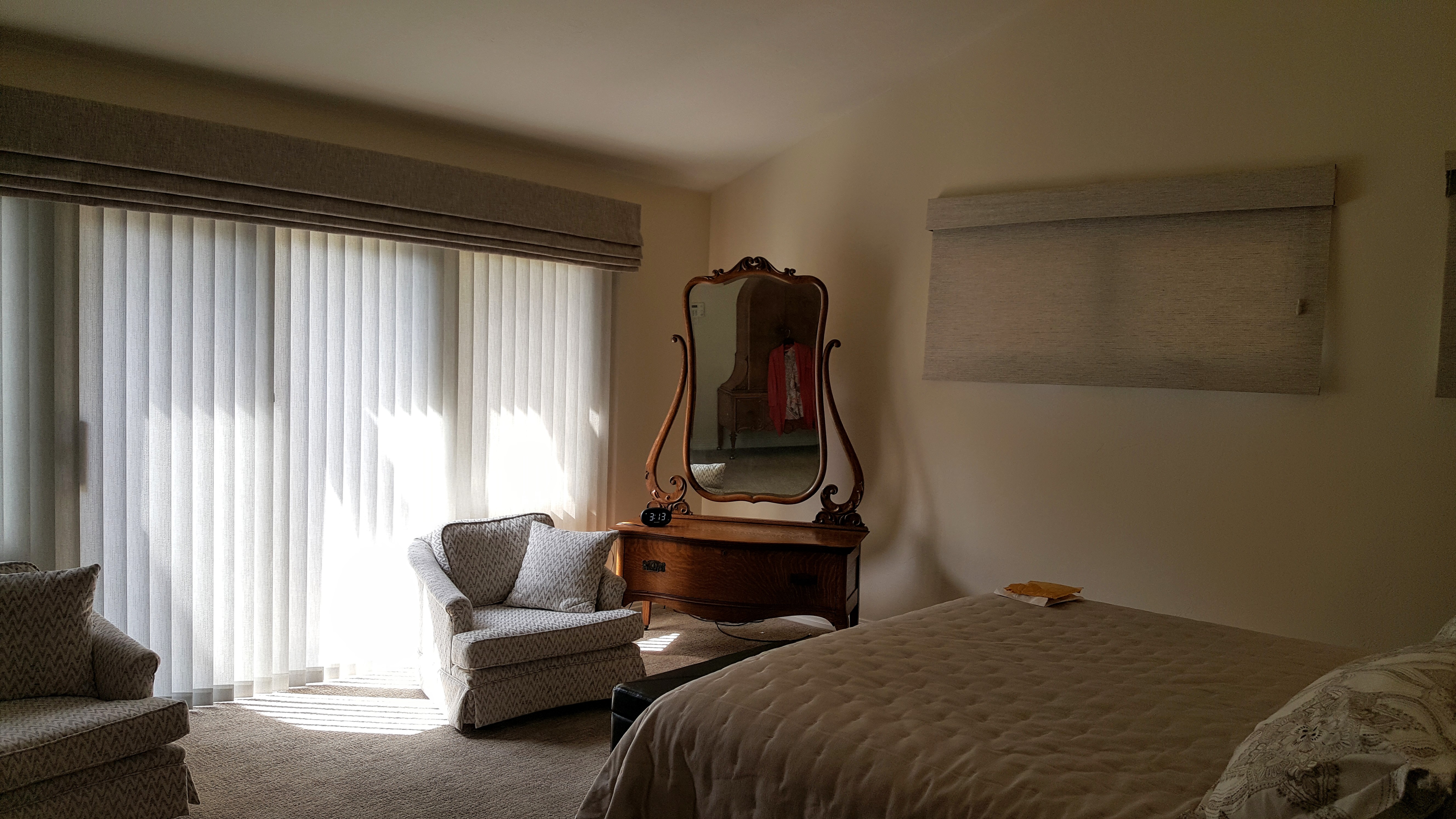 Large Roman Valance over vertical coordinates perfectly with Woven Natural Roman shades in a master bedroom in Point Loma