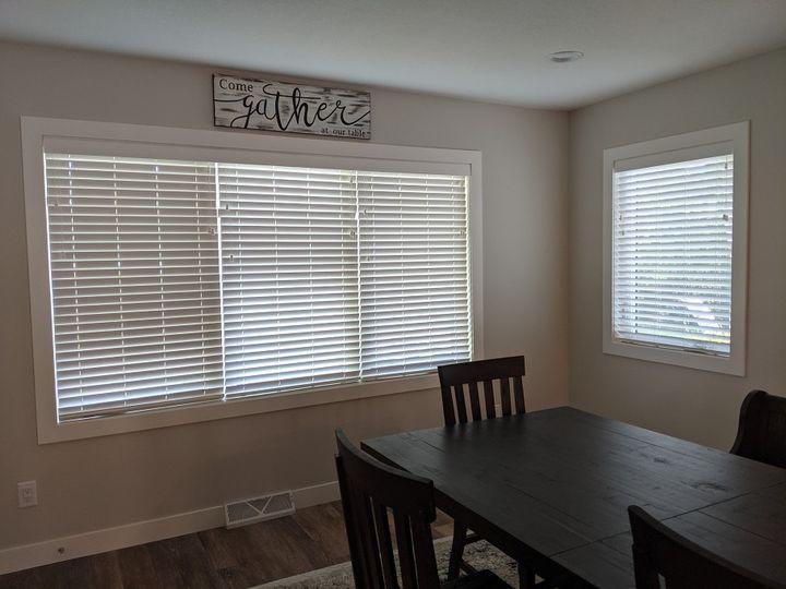 What's the best way to make dinnertime feel more intimate? We think it's the White Faux Wood Blinds that we installed in this Cedar Falls home! They create a cozy effect in this beautiful space.  BudgetBlindsCedarFallsWaterloo  FauxWoodBlinds  CedarFallsIA  FreeConsultation  WindowWednesday