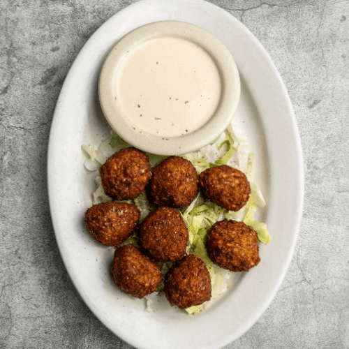 Falafel Sandwich Served with Tahini Sauce and French Fries
