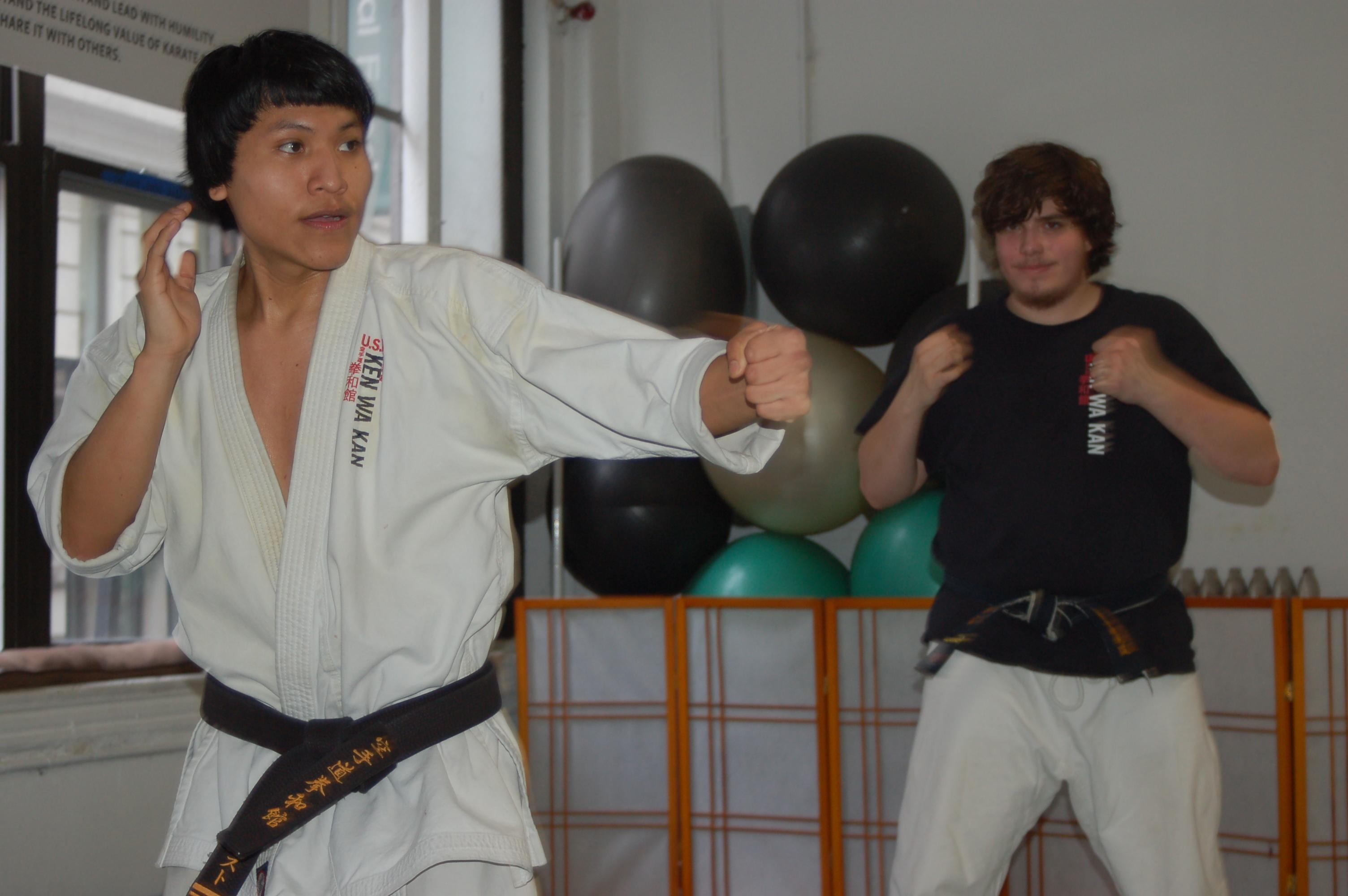 Sempai Augusto shows hook punch in his Sunday afternoon class