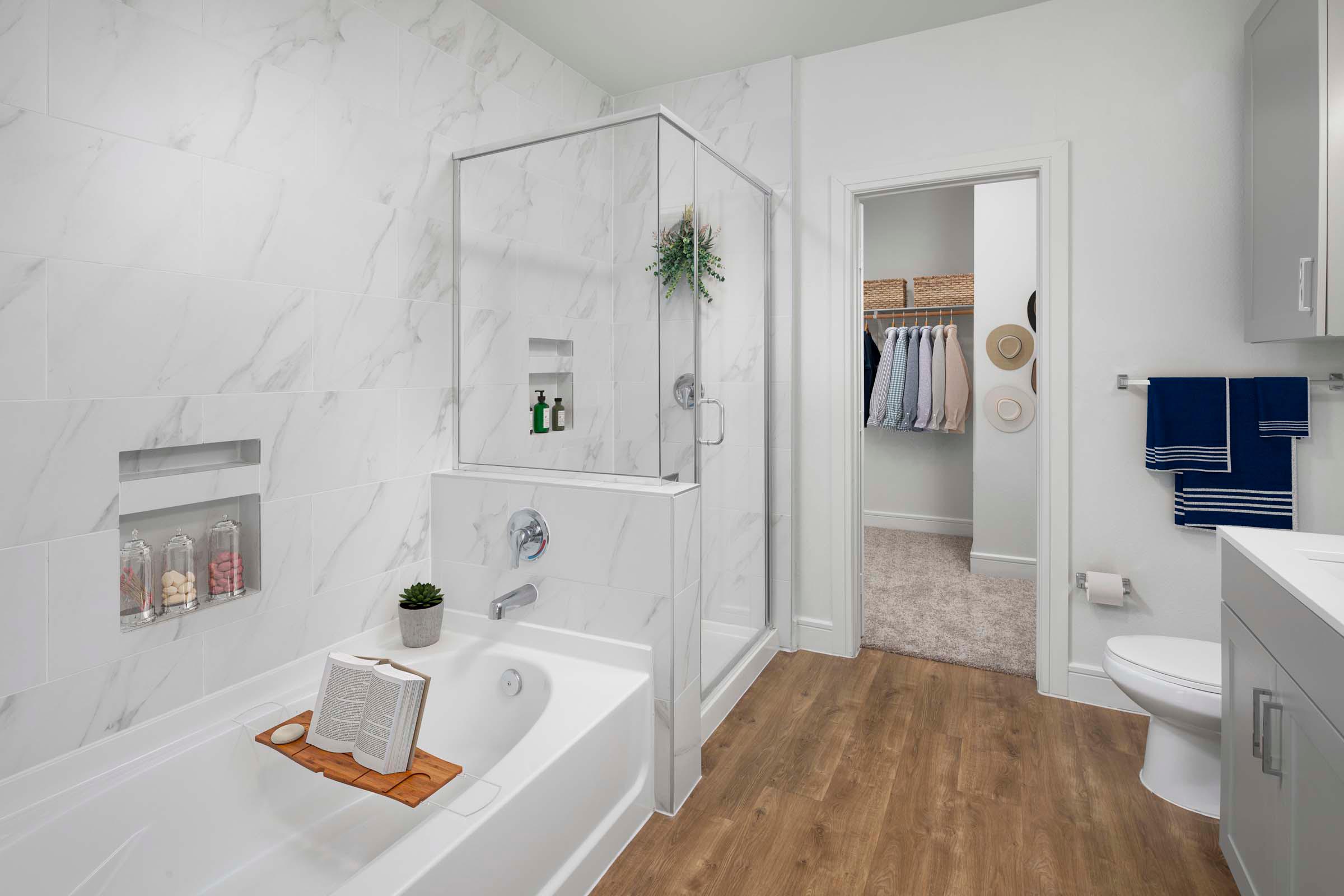 Villas townhome bathroom with gray cabinets, walk-in shower and bathtub at Camden Greenville