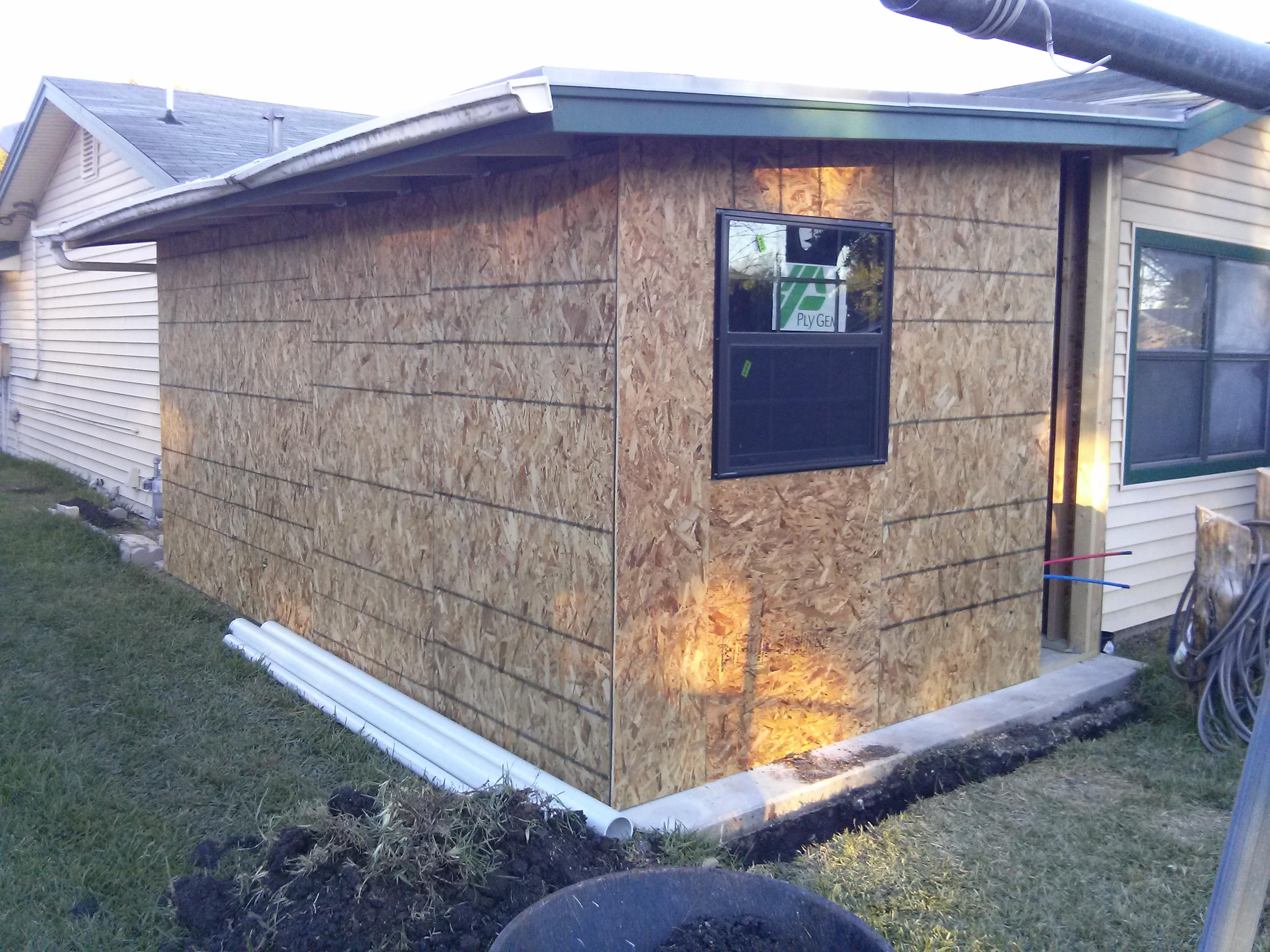 Installing plywood and window for addition