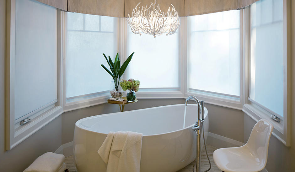 Bay Windows don't have to be complicated!  White custom motorized Roller Shades paired with custom Valances really soften the feel of this bathroom in Point Loma.   BudgetBlindsPointLoma  FreeConsultation