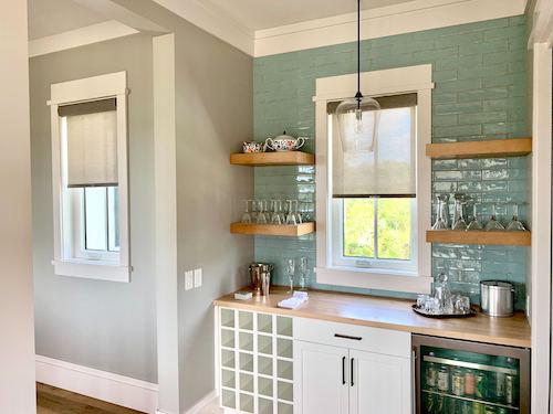 Clean and simple, these light brown solar shades pull together this fun local bar area! They'll keep your countertops and kitchenware protected from the harsh UV rays, too. Our solar shades can come motorized and cordless, allowing for super easy use! Call (843) 837-4060 for a free in-home design co