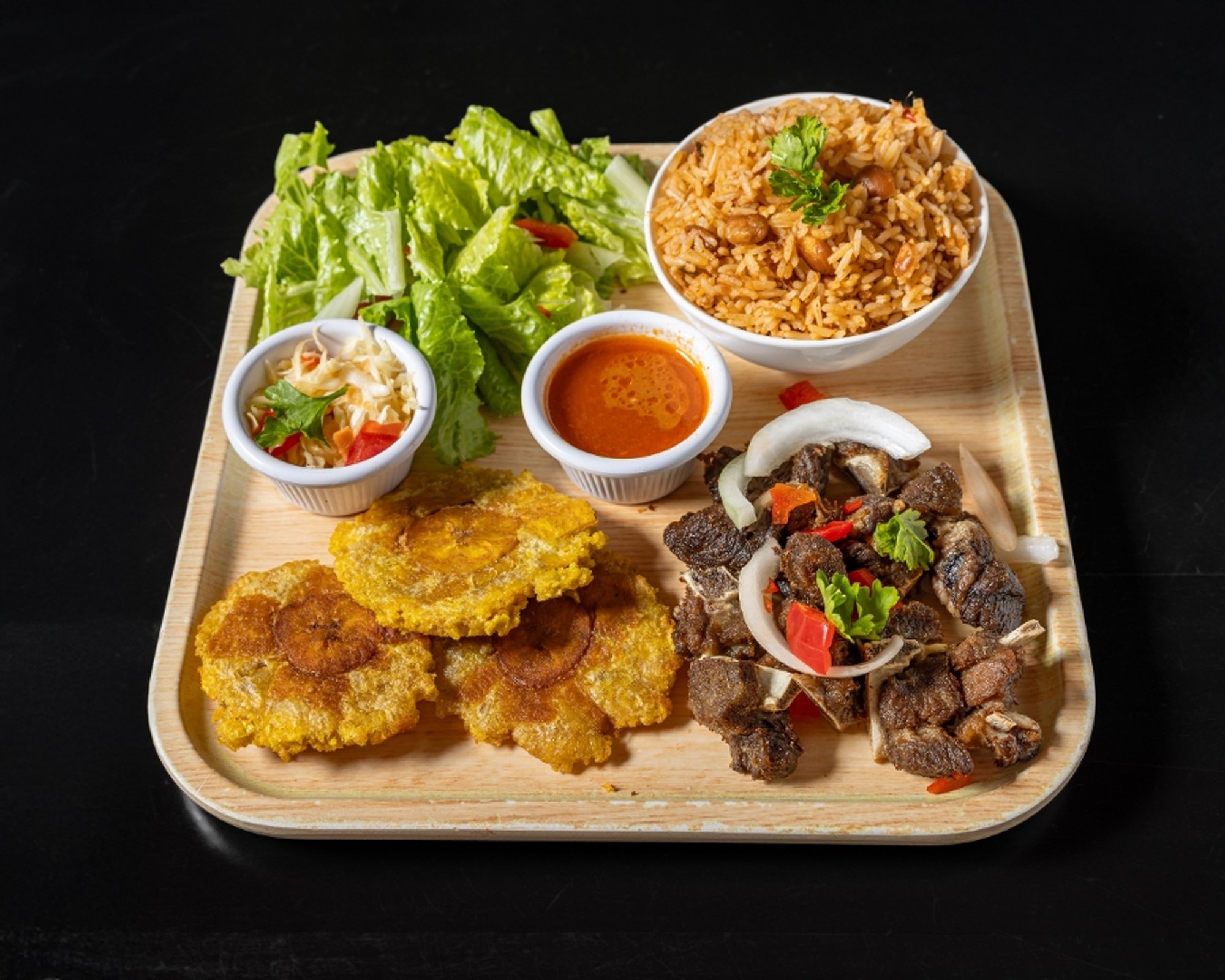 Fried Goat (Served with Plantain and 1 Choice of White Rice, Rice and Beans, Djondjon Rice or Whi...