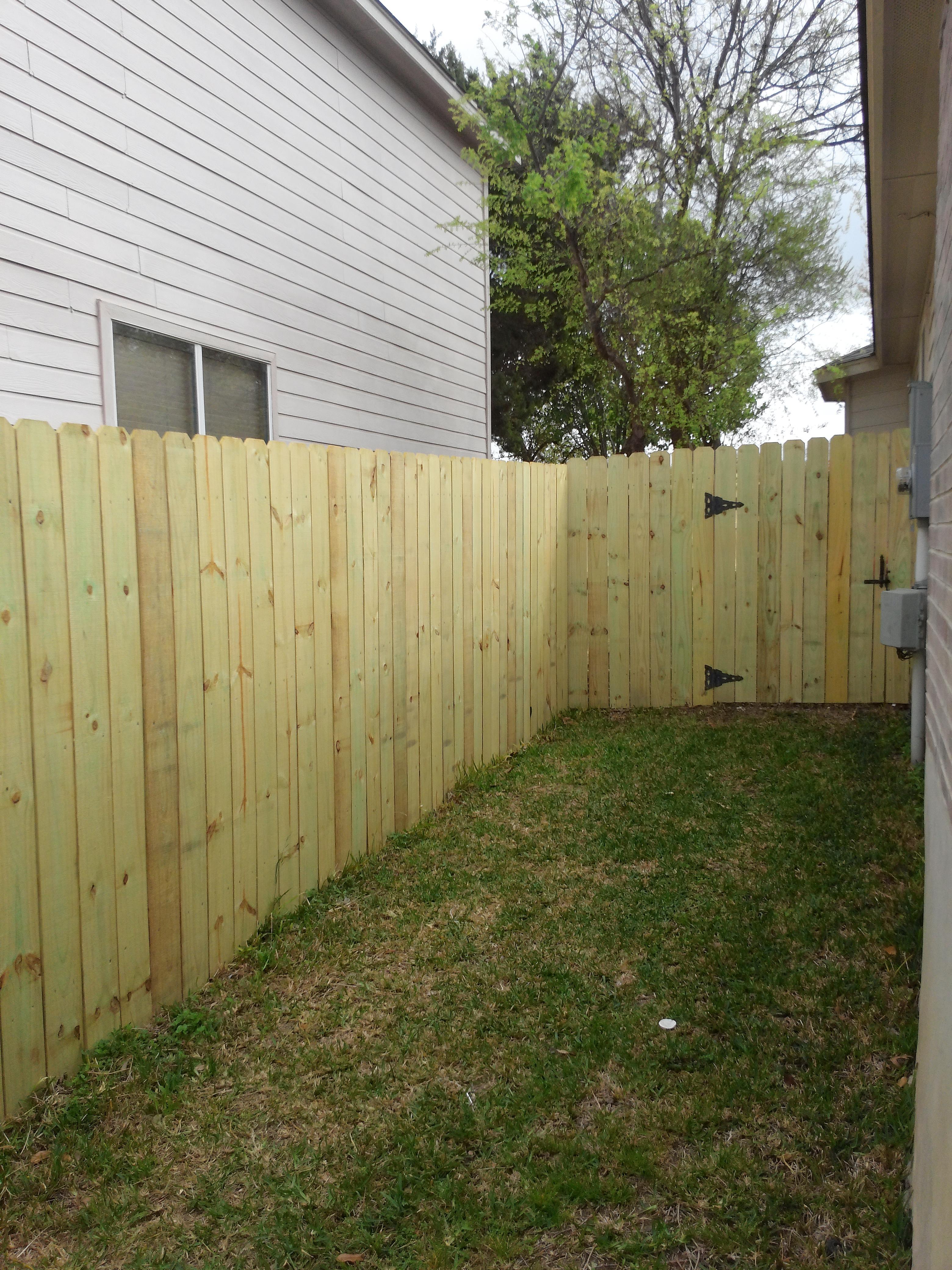 Privacy fence with treated lumber.