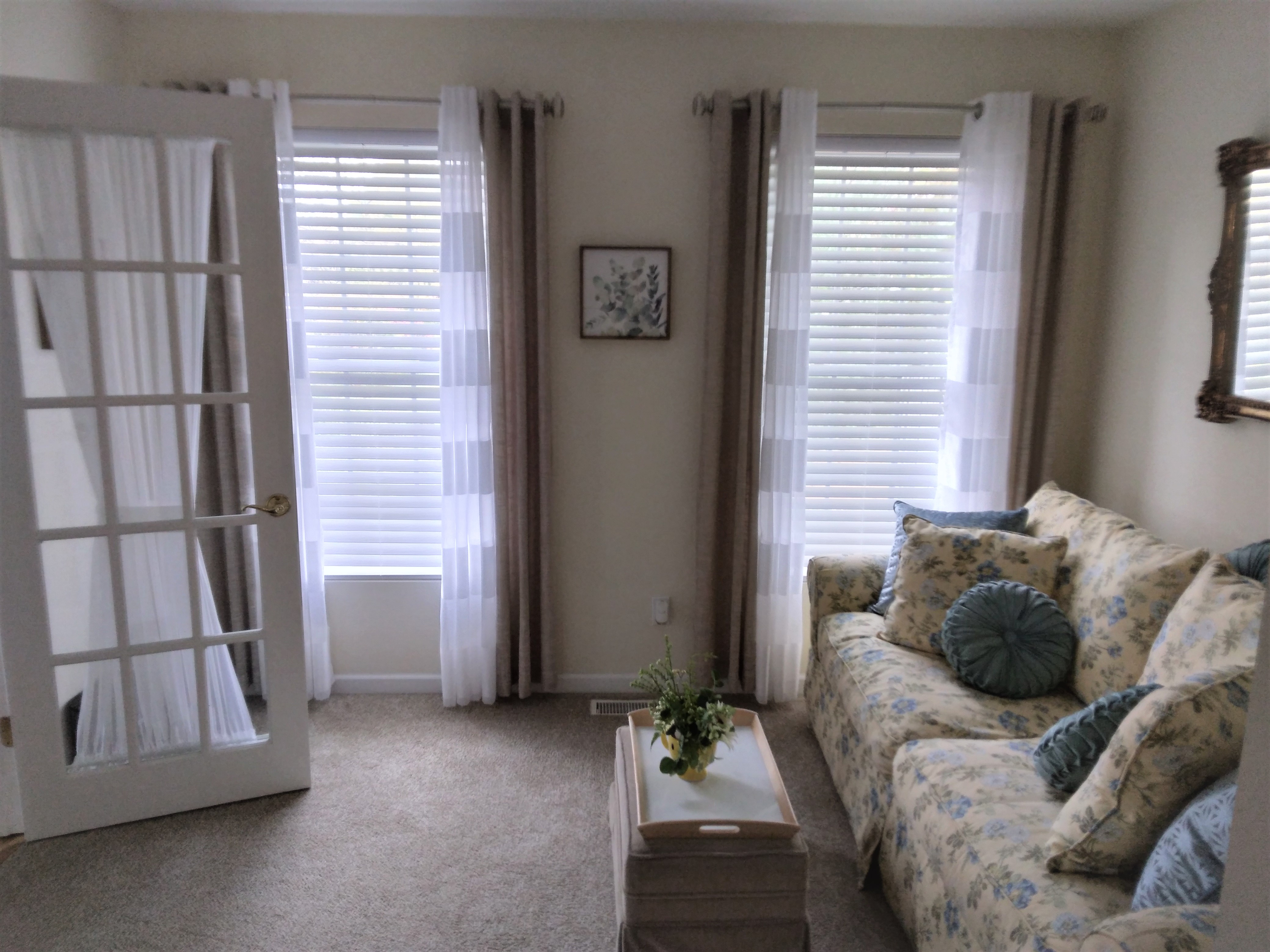 Cordless white faux wood blinds in Springfield Illinois family room.  BudgetBlinds  WindowCoverings  Blinds  SpringfieldIllinois