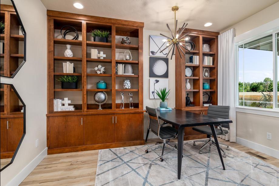 Home office with built in shelves and cabinets