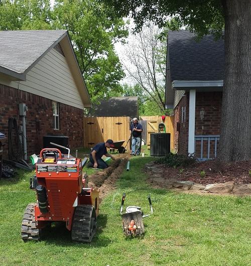 Installing a french drain system to keep this customer's backyard dry!