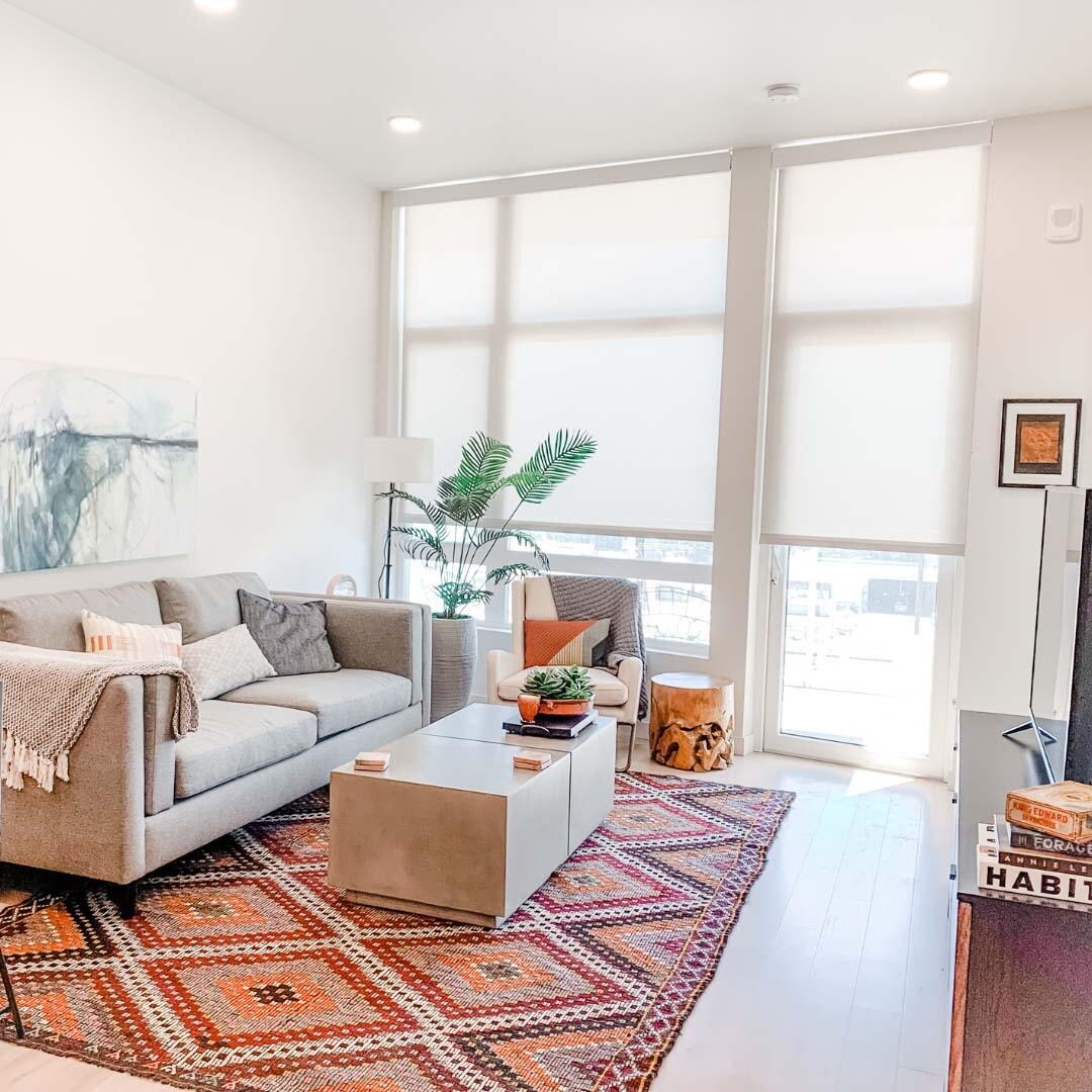 Roller shades in a living room with fabric wrapped cassette