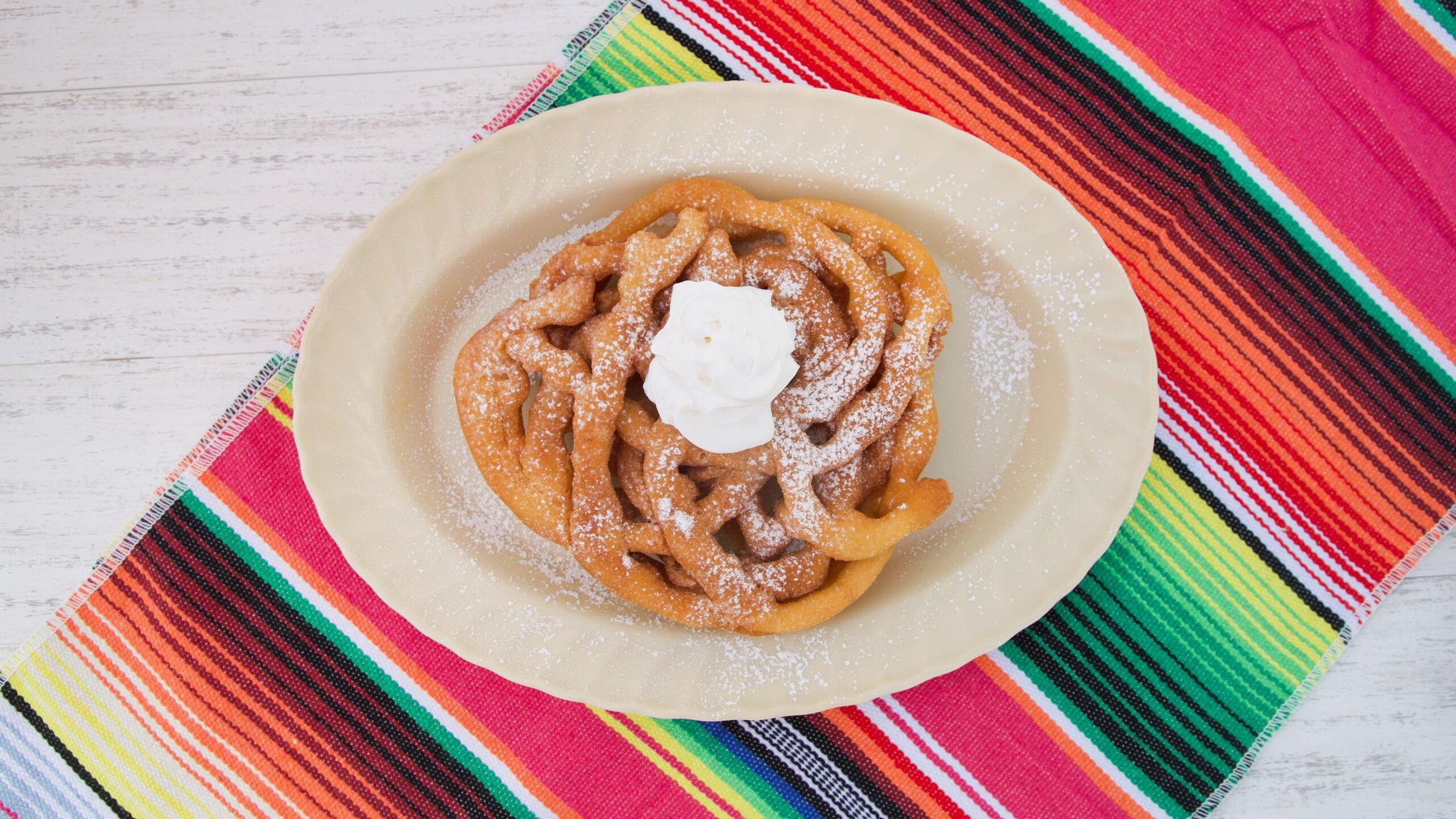 Funnel Cake with Powdered Sugar and Whipped Cream