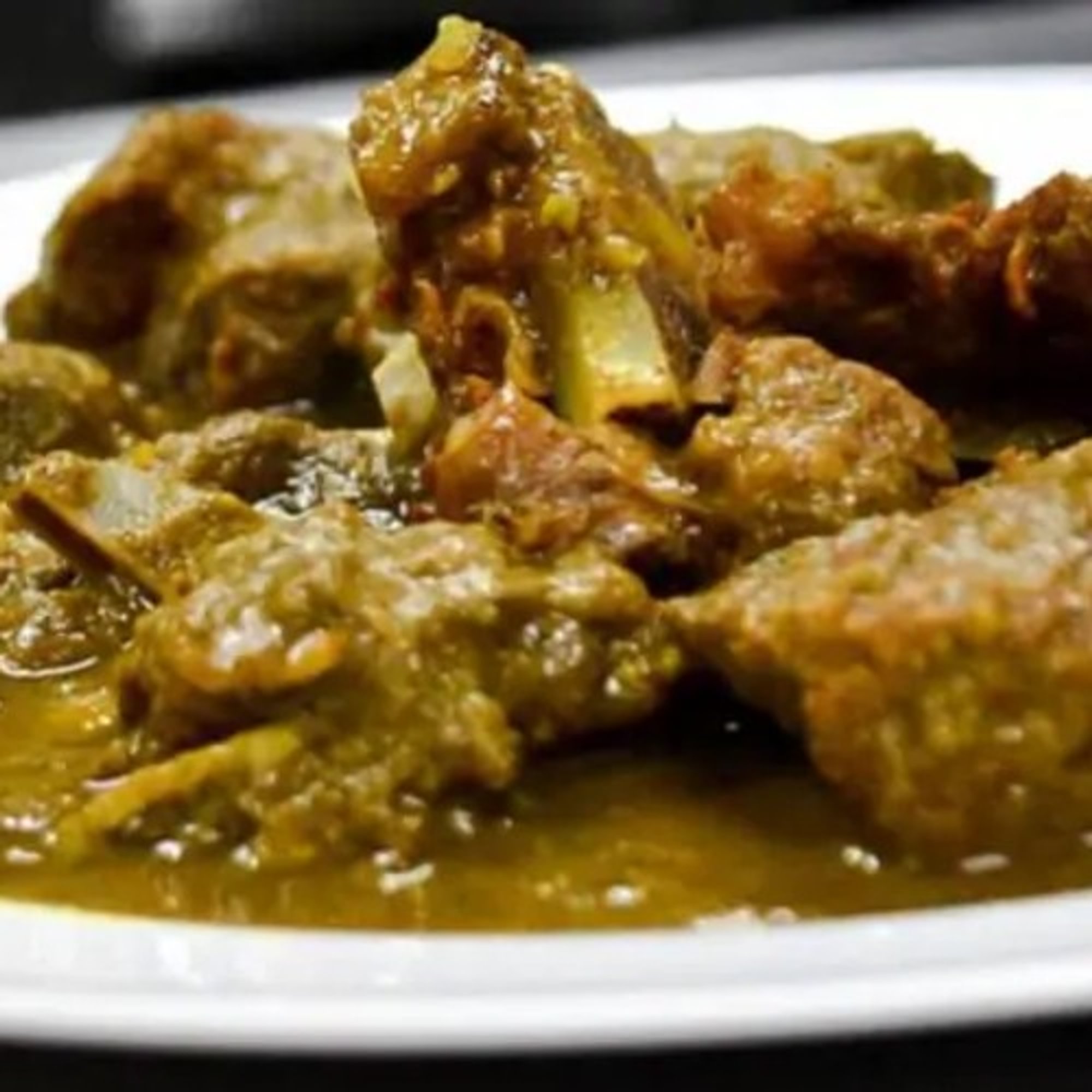 Curry Goat Served with Jasmine Rice, Cabbage and Plantains
