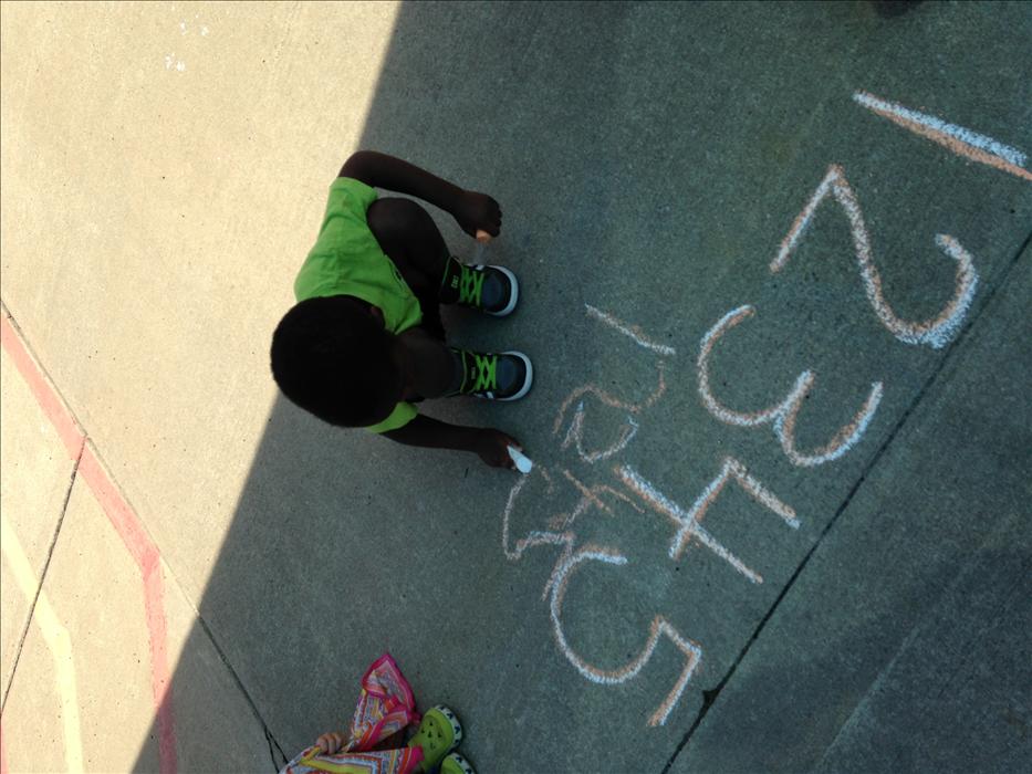 While running and exercising outdoors, we offer various materials and opportunities for children to learn. This chld is practicing his fine motor skills, literacy and math skills with the use of chalk. Outdoor enhancement boxes are provided to promote learning outdoors. Some of the boxes include items for dance such as scarves and instruments. Creative expression with materials such as markers, paper, challk and even paint, and so much more. Our goal is to make every child have a passion for learning, espec