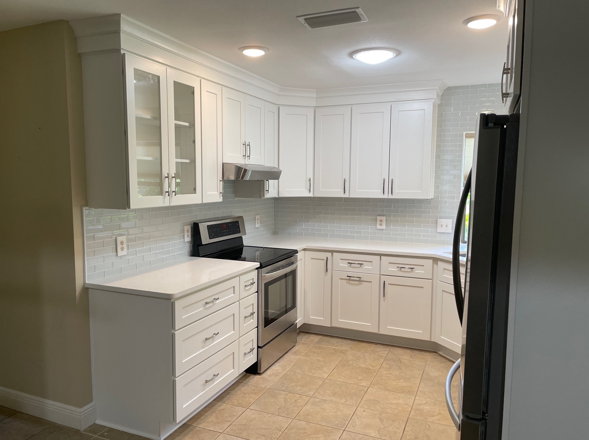 Look at this beautiful kitchen just completed by Kitchen Tune-Up Pensacola in Gulf Breeze, FL. New cabinets and backsplash with crown molding taken all the way to the ceiling.