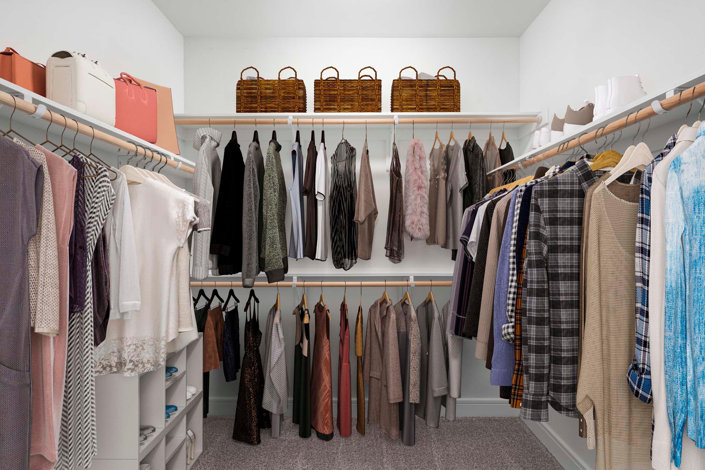 Large walk-in closet with built-in wood shelves and racks at Camden Greenville