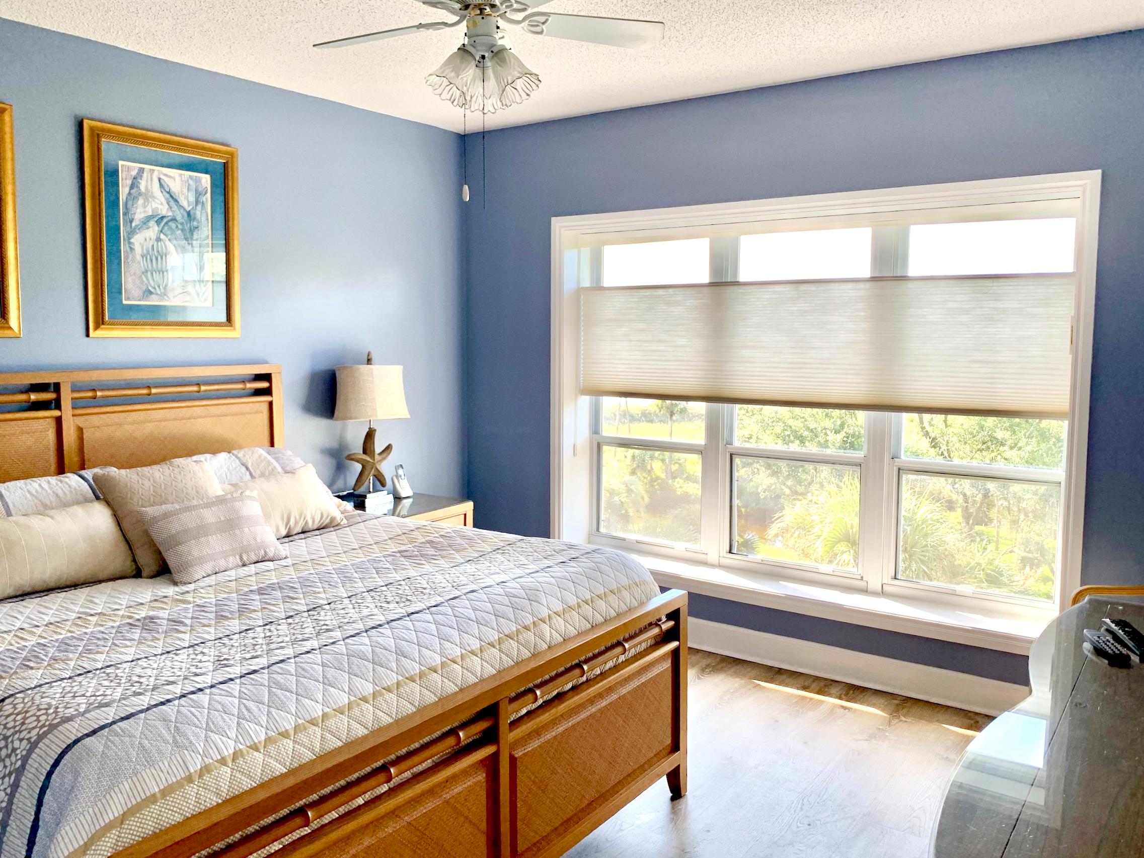 Our functional cellular shades are the perfect addition to this gorgeous Southern bedroom in a local home. We love how these shades illuminate the space, while allowing for ample privacy. Plus, our cellular shades are energy efficient! If you're ready to upgrade your Pooler or Statesboro home, give