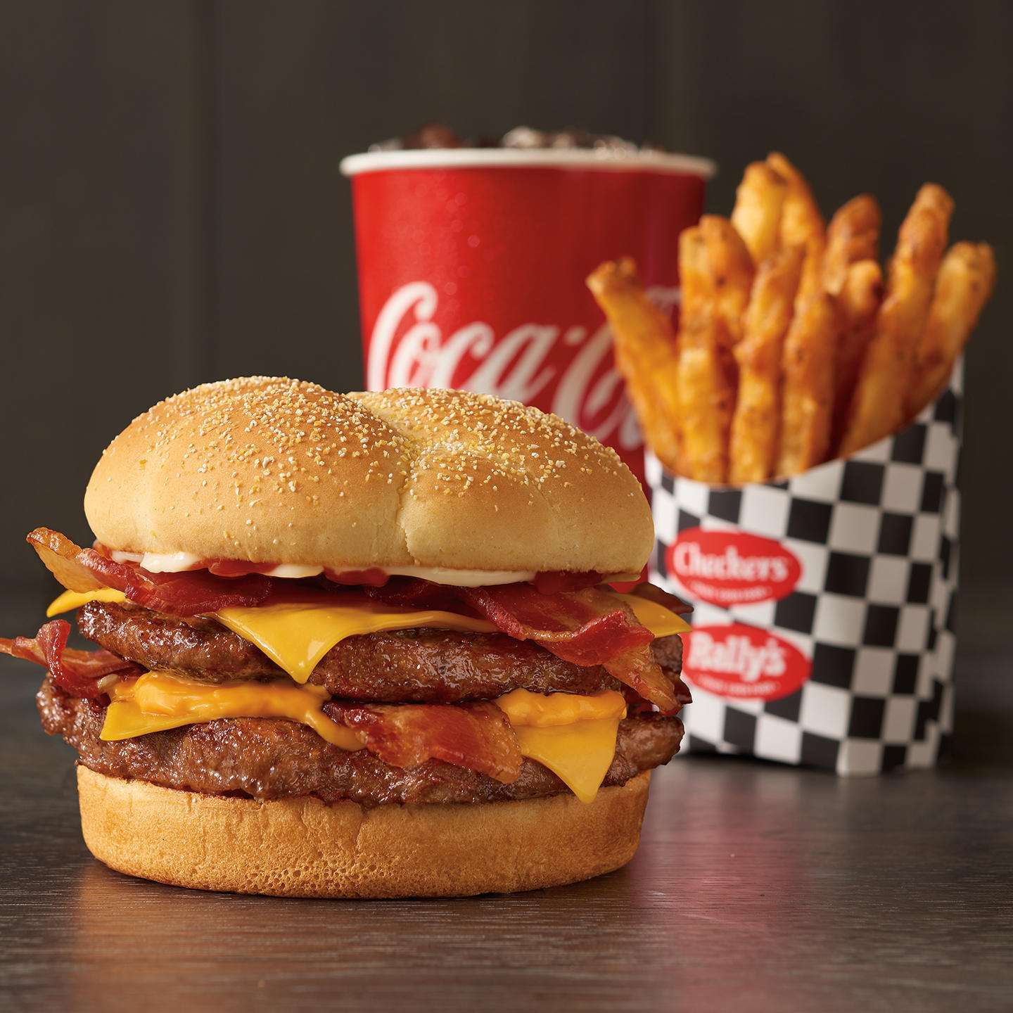 Beef. Cheese. Bacon. Repeat.
Double up on the beef. Triple up on the cheese. And multiply the bacon FOUR TIMES. That’s a towering burger stacked with flavor.