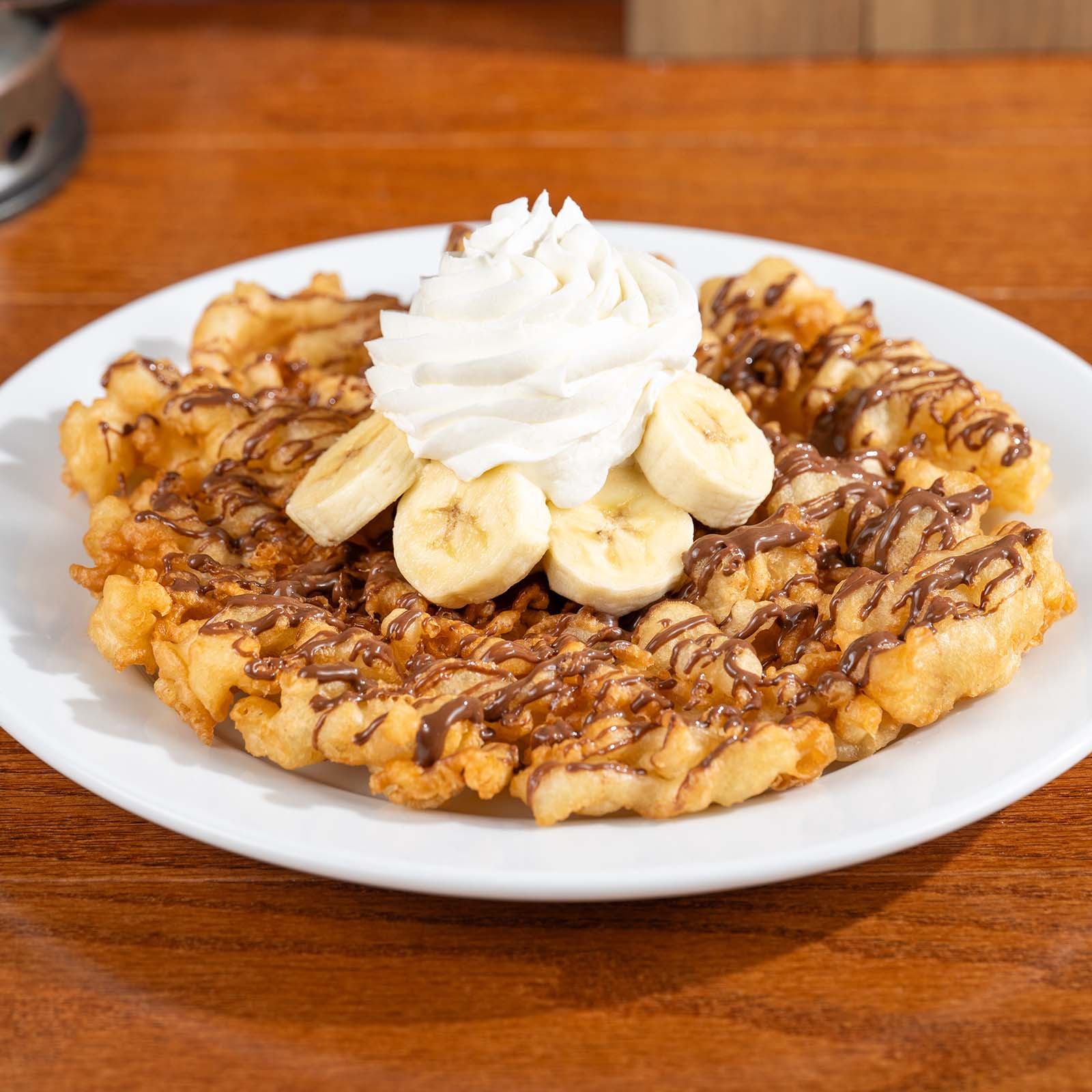 Funnel Cake with Chocolate-Hazelnut Spread, Bananas, and Whipped Cream