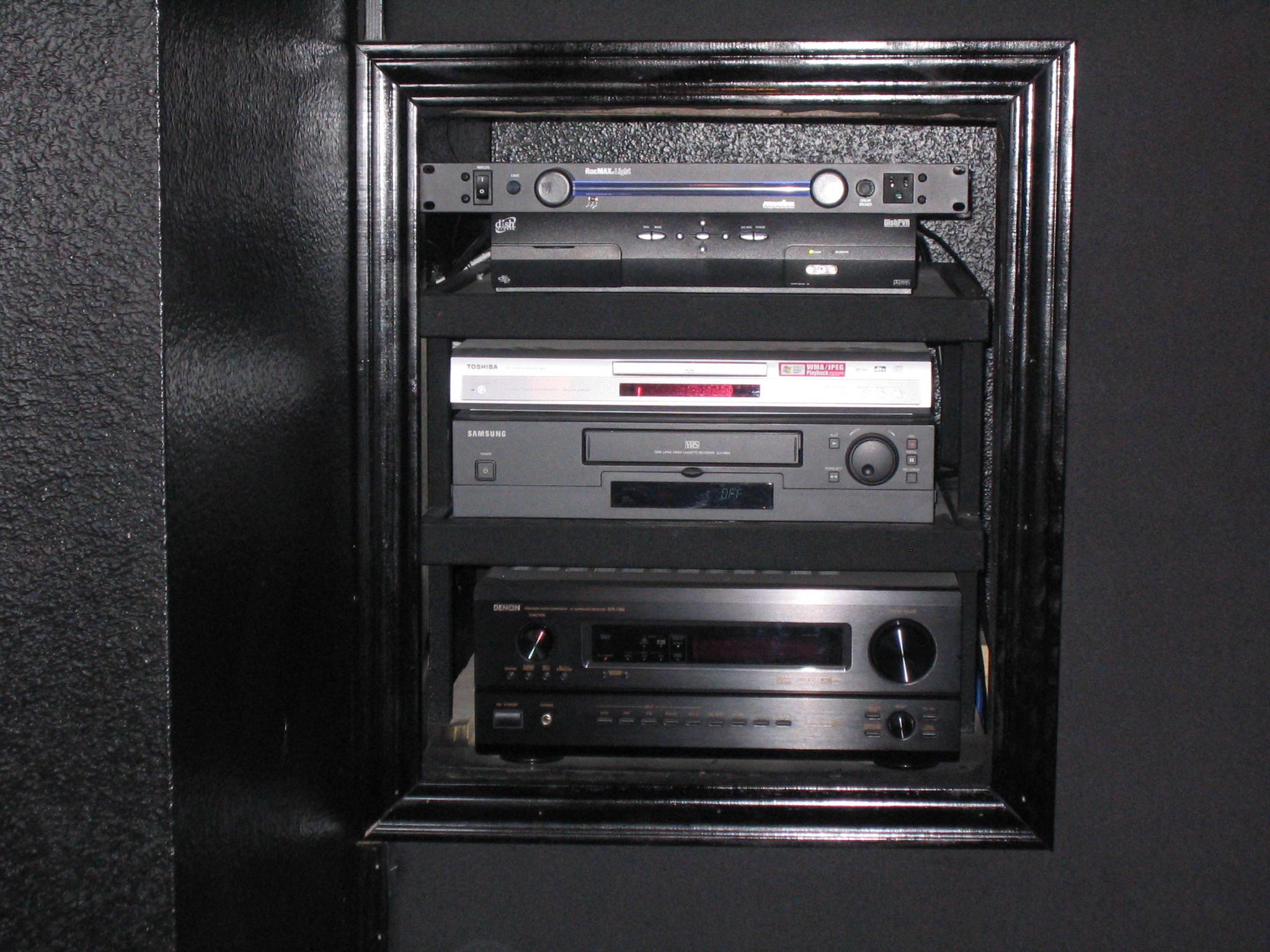 Equipment rack with 5.1 surround sound stereo.