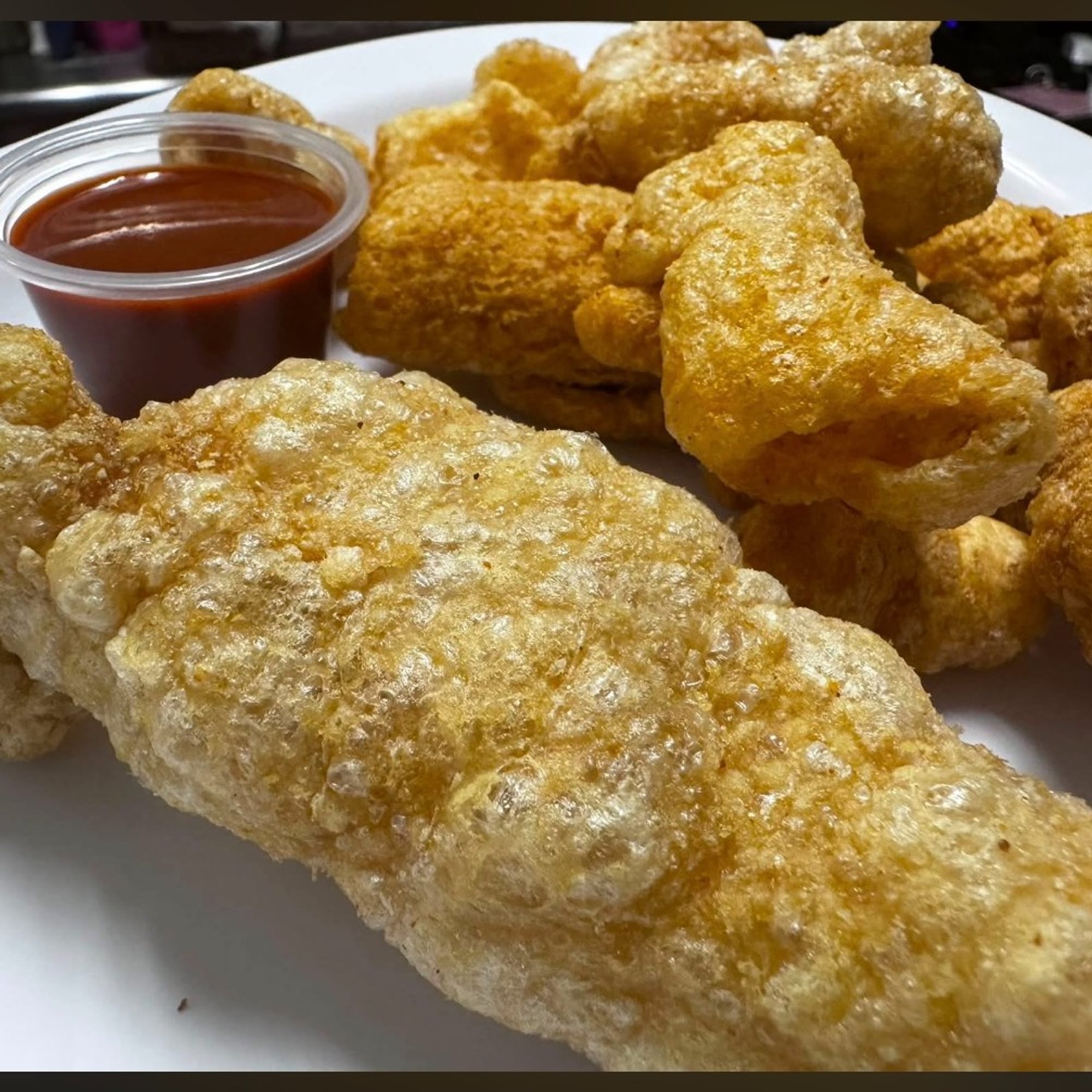 Chicarrones (pork rinds w/Salsa Valentina)