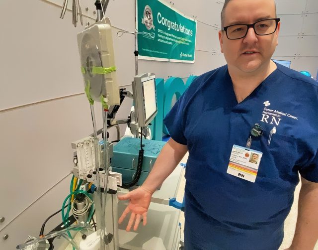 Nurse showing ECMO machine