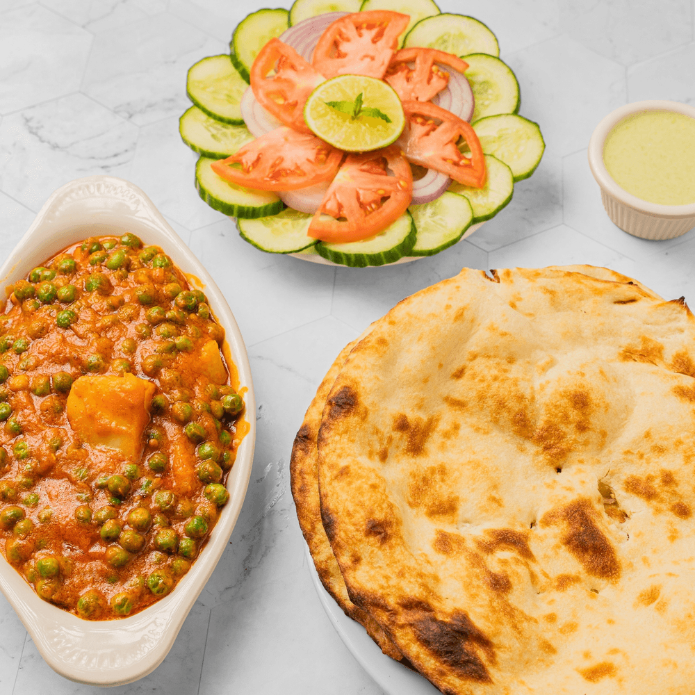 Any one vegetable dish in our menu +2 Plane Naan + Can of Soda +Salad +Green Sauce