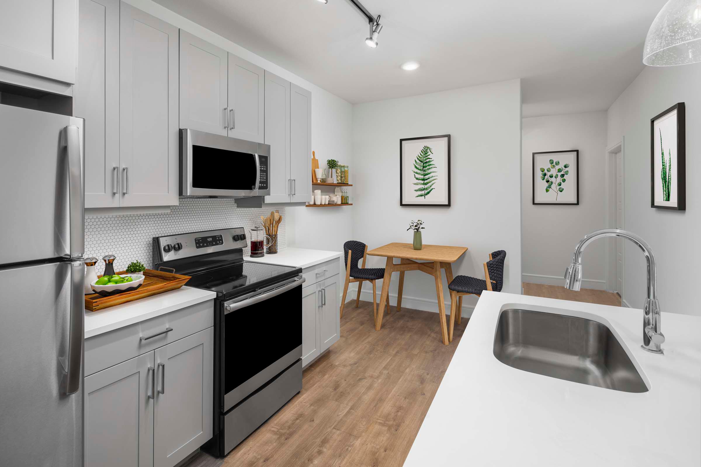 Flats one bedroom dining room and kitchen with gray countertops at Camden Greenville