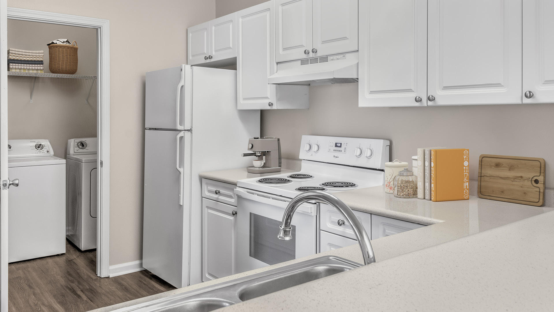 Kitchen with laminate countertops and white appliances next to laundry room at Camden Governors Village Apartments in Chapel Hill, NC