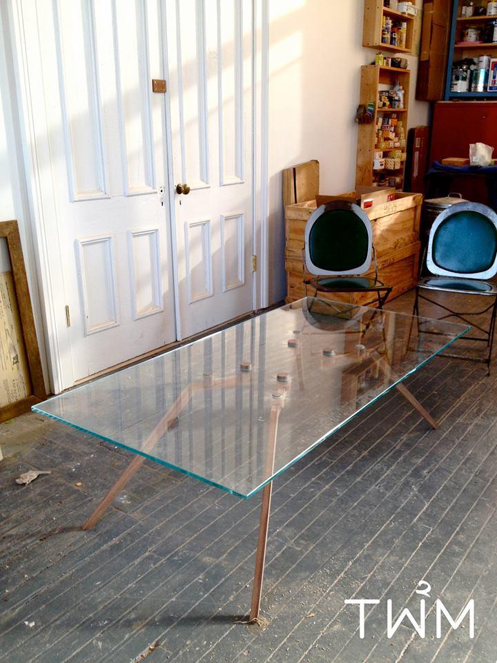 A custom glass table with no mechanical connections 