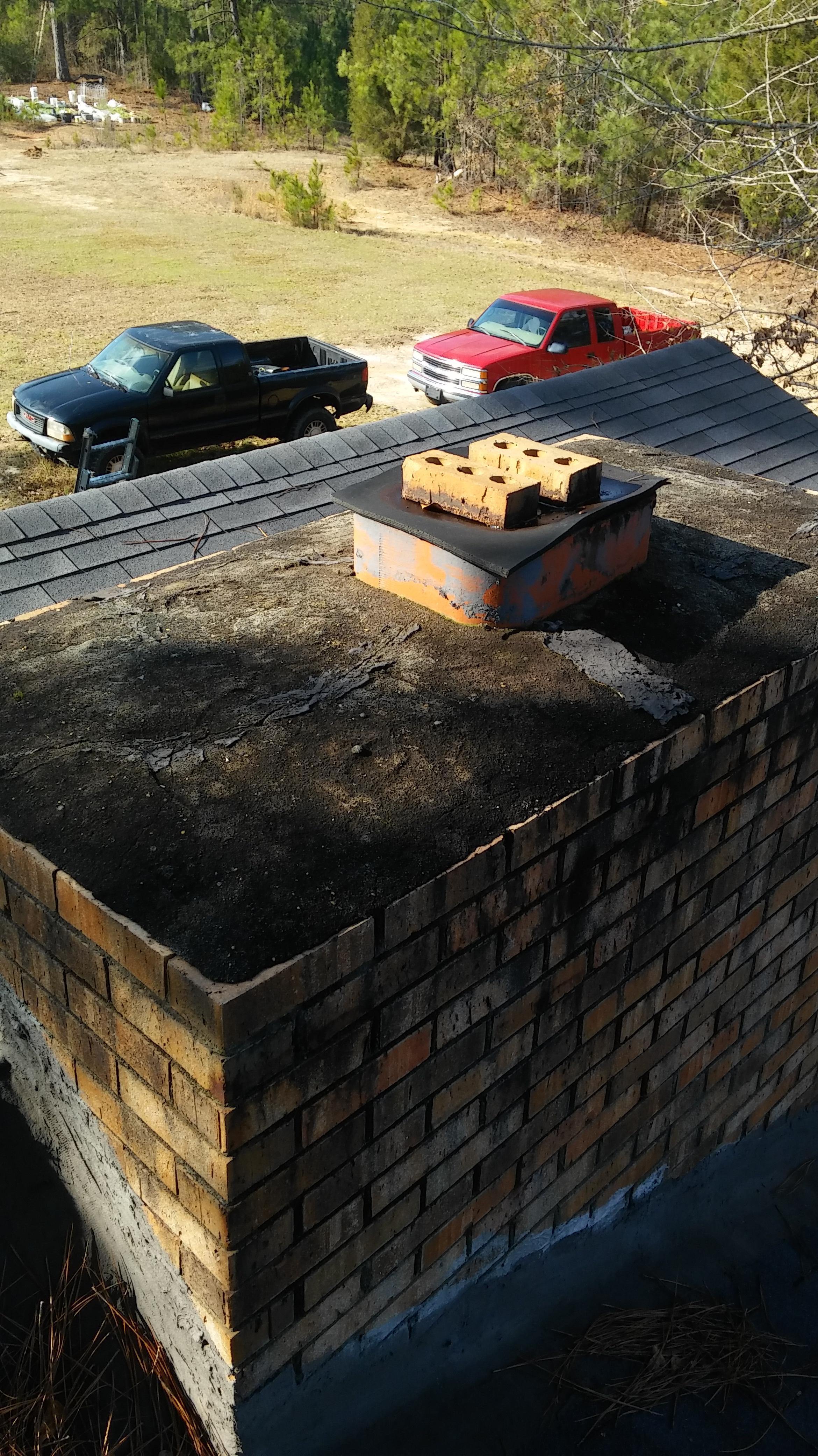 Cracked chimney cap and missing flue vent.