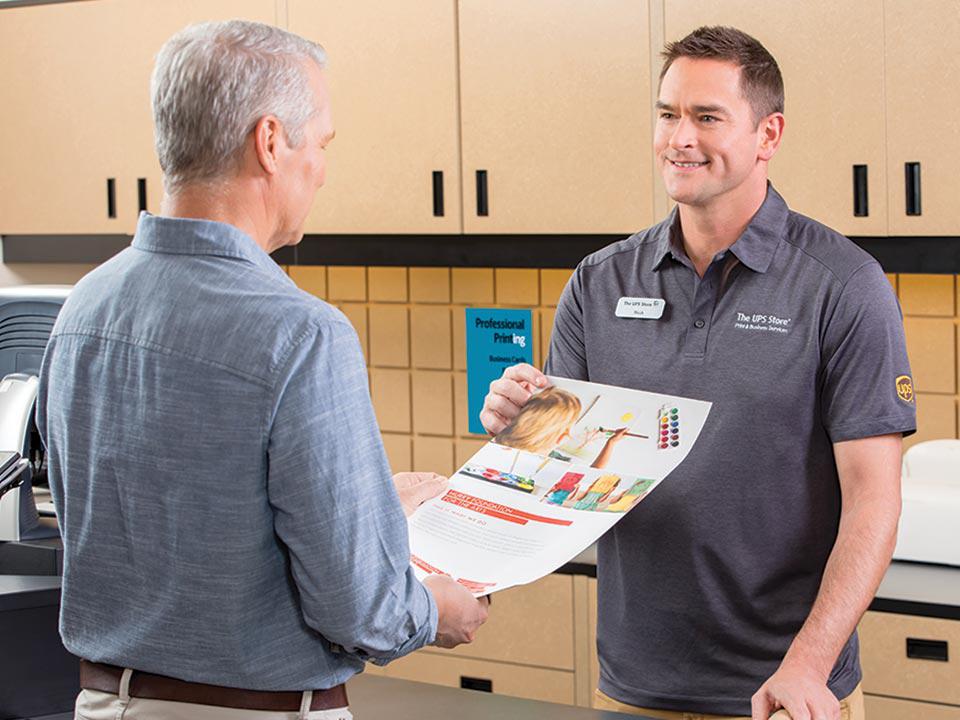 customer with printed flyers at the ups store