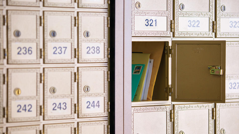 A bank of locked mailboxes. One mailbox is open, ready for your mail.