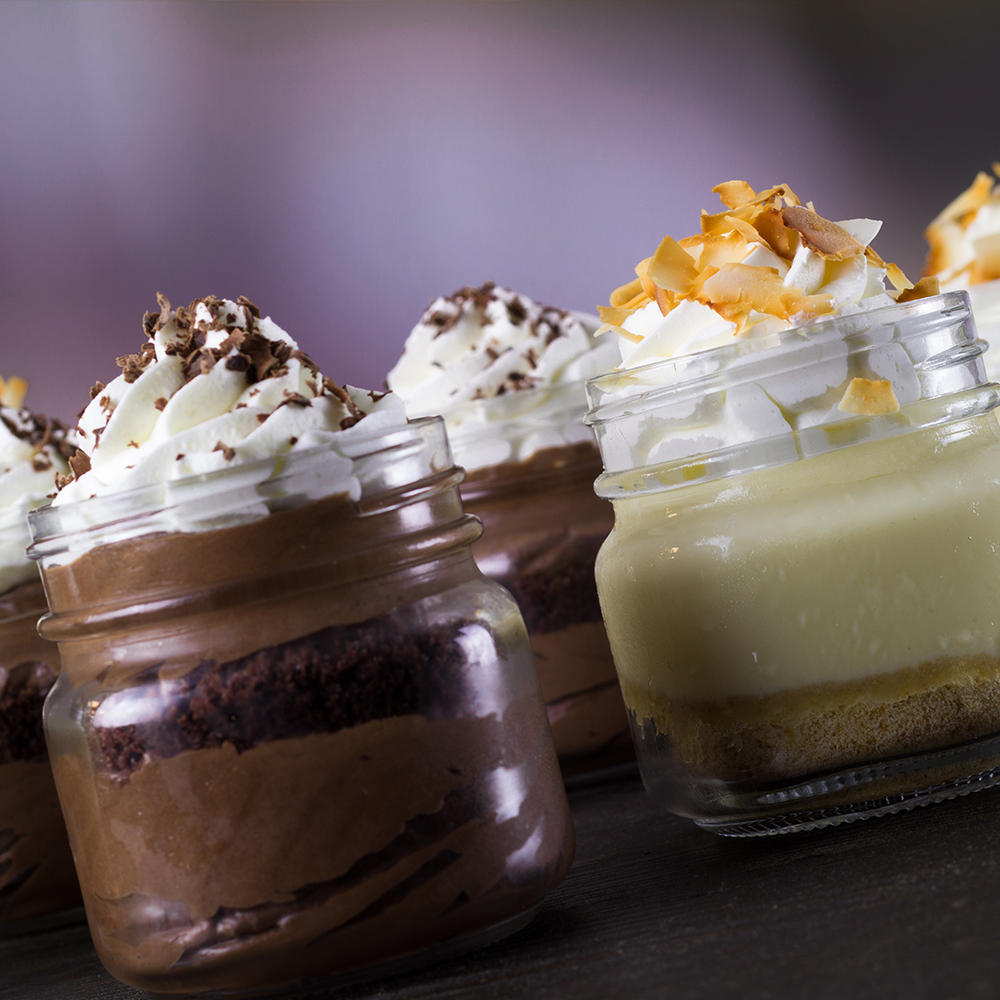 Our Signature Mason Jar desserts - Coconut Cream Pie and Belgian Chocolate Mousse.