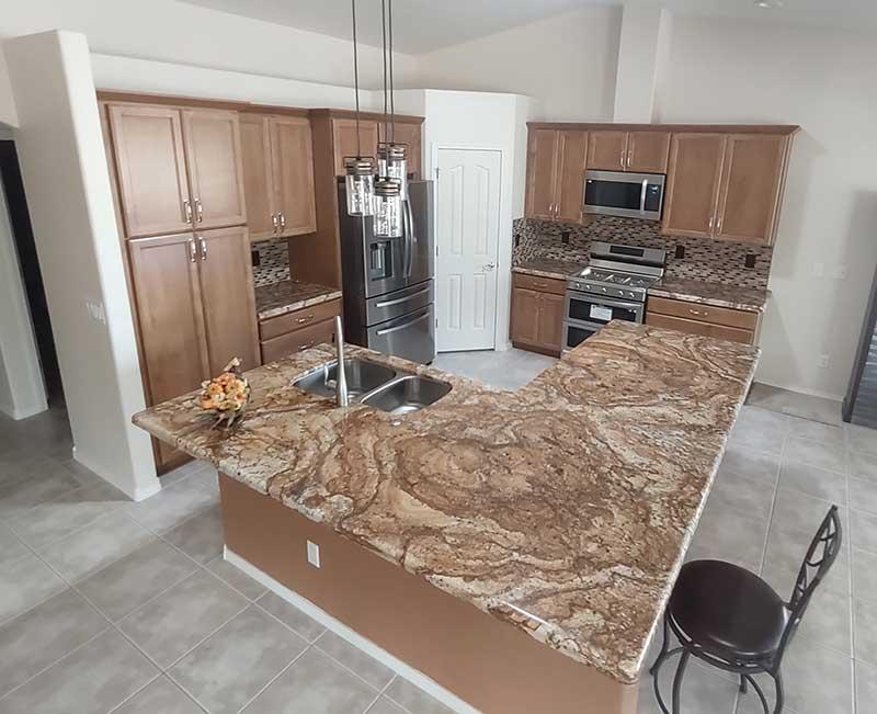 Kitchen with large island featuring solid-surface top