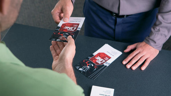 automotive door hangers handed to a customer