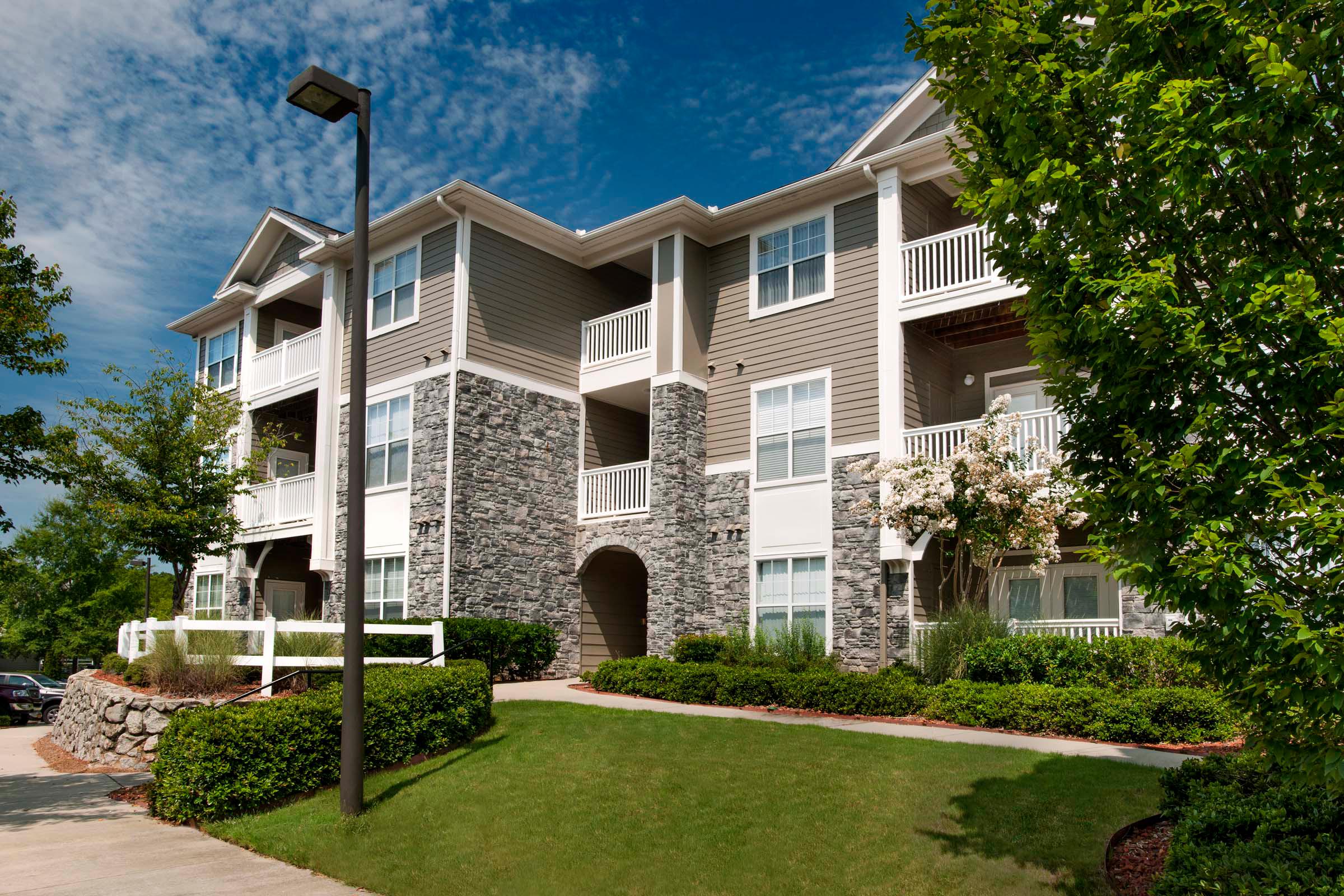 Building exterior showing private balconies and patios as well as beautiful landscaping