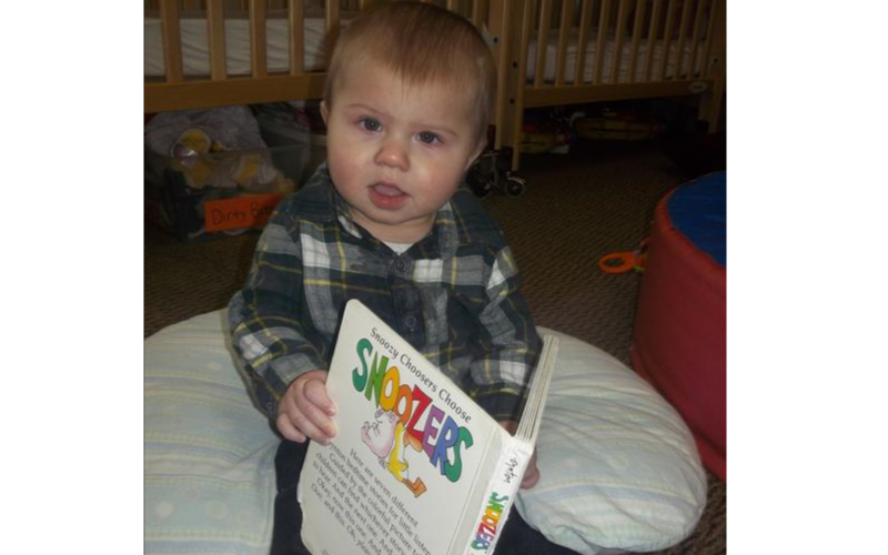 Beginning as young as in our infant classrooms, we strive to foster a lifelong love for reading! Our unique classrooms promote a least restrictive environment where children are encouraged to explore different toys and materials that are intentionally organized at their own level to allow for independent exploration. This includes a wide variety of books! Here, one of our babies was able to access a book and explore it at his own leisure!